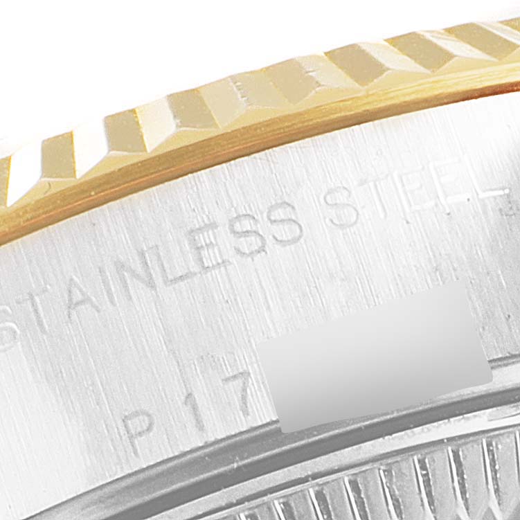 This close-up image of a Rolex Datejust 79173 Women's Steel and Gold (two tone) Champagne Dial 79173 Women's Steel and Gold (two tone) Champagne Dial watch shows part of the fluted bezel and the edge of the stainless steel case back.