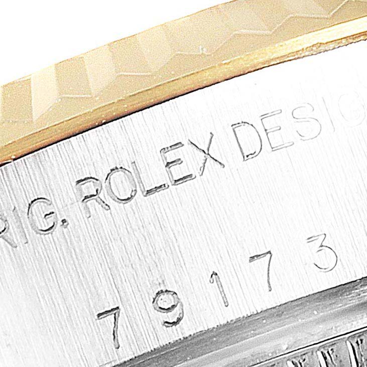 The image shows a close-up of the engraved case side of a Rolex Datejust 79173 Women's Steel and Gold (two tone) Champagne Dial 79173 Women's Steel and Gold (two tone) Champagne Dial watch, featuring the model number and brand name.