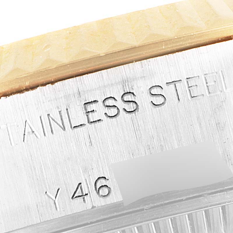 This close-up image of the Rolex Datejust 79173 Women's Steel and Gold (two tone) Mother of Pearl Dial 79173 Women's Steel and Gold (two tone) Mother of Pearl Dial watch shows the engraved text "STAINLESS STEEL" on its caseback.