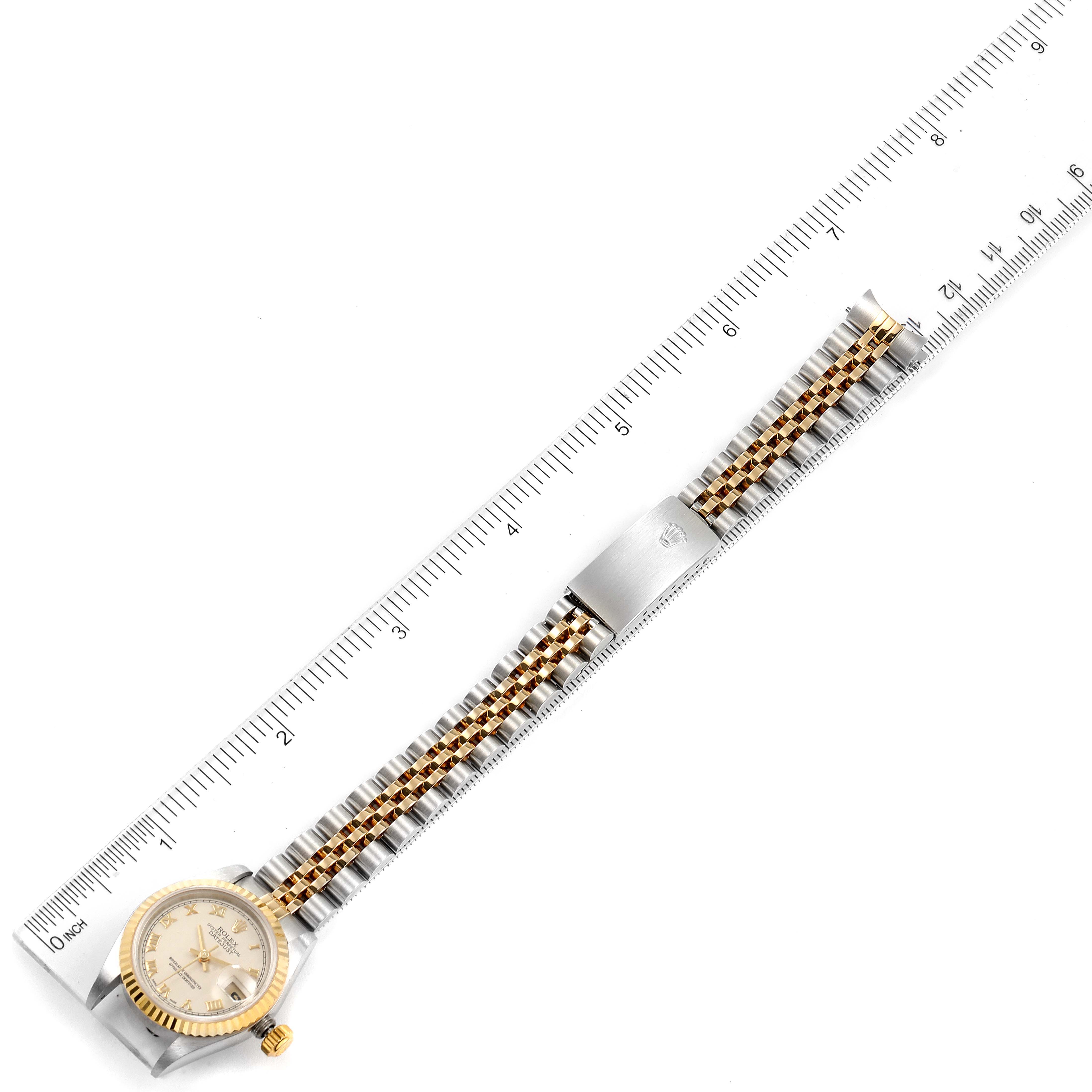 This image shows a bird's-eye view of a Rolex Datejust 79173 Women's Steel and Gold (two tone) Beige Dial 79173 Women's Steel and Gold (two tone) Beige Dial watch next to a ruler, highlighting its face and bracelet.