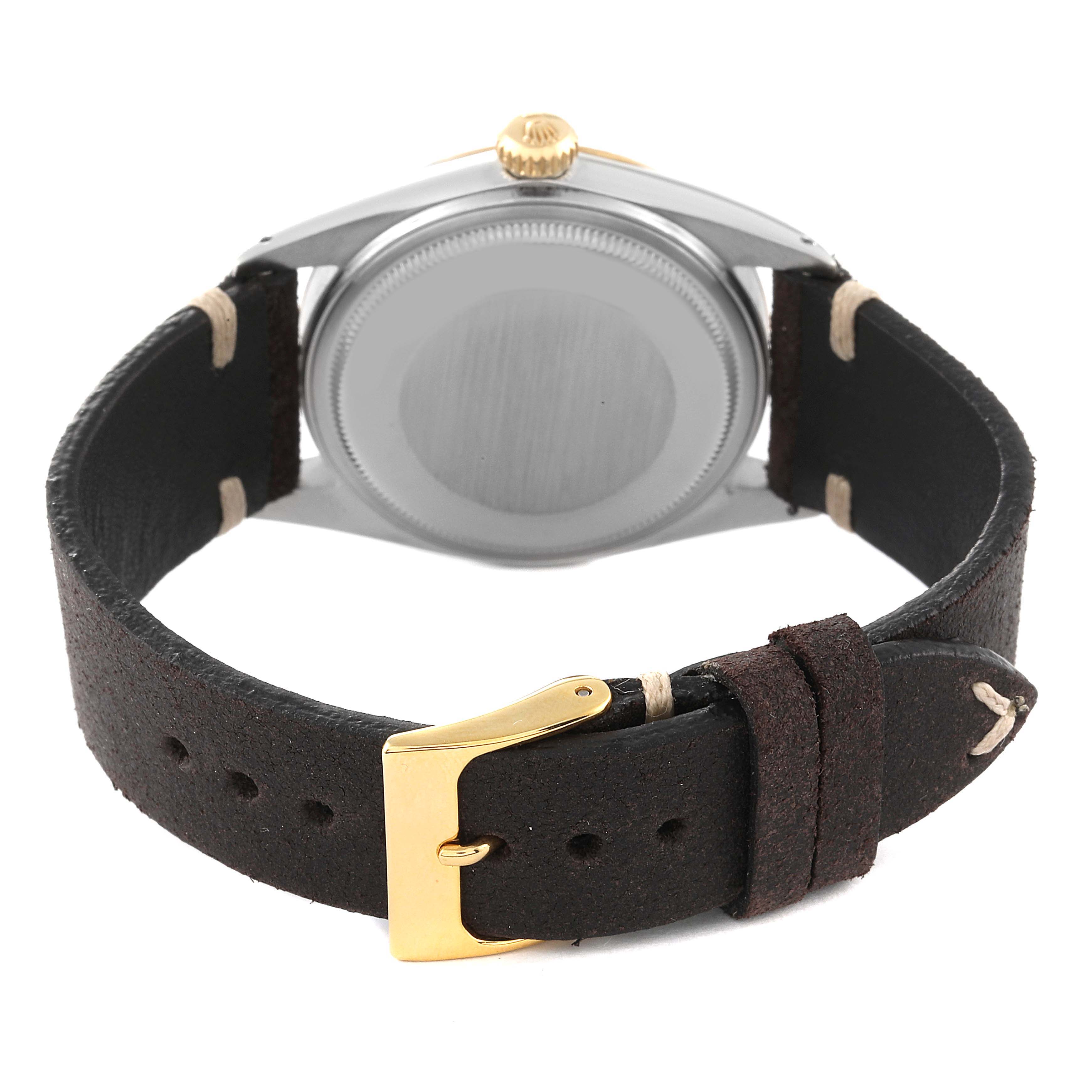 The image shows the back view of a Rolex Datejust 16013 Men's Yellow Gold Champagne Dial 16013 Men's Yellow Gold Champagne Dial watch with a leather strap and a gold buckle.