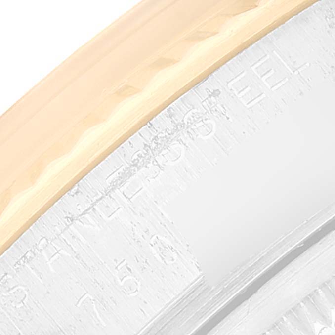 This image shows a close-up of the fluted bezel and part of the edge of the dial of a Rolex Datejust 16013 Men's Yellow Gold Champagne Dial 16013 Men's Yellow Gold Champagne Dial watch.