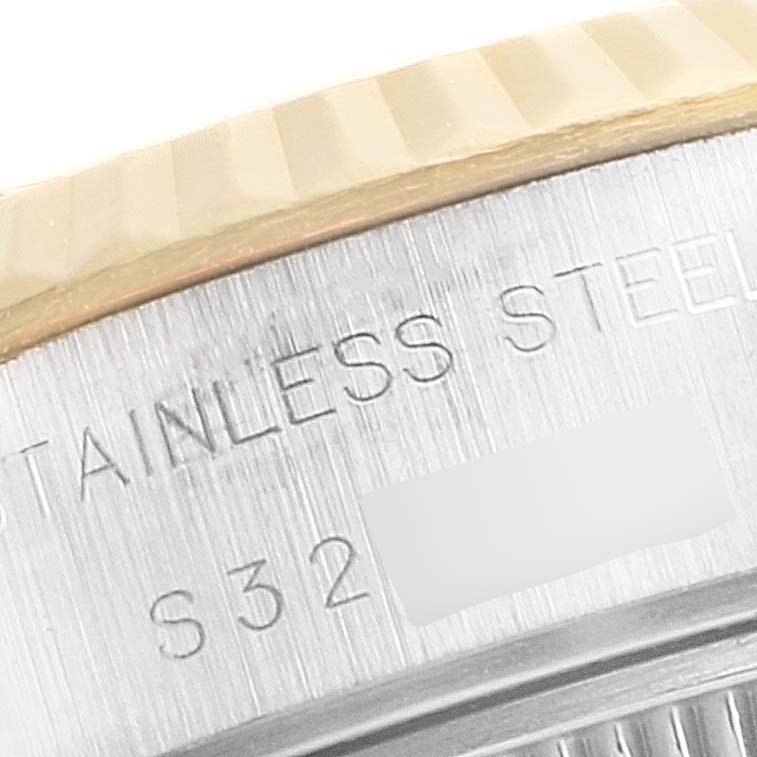 This close-up image shows the engraved stainless steel detailing on the bezel and case back edge of a Rolex Datejust 69173 Women's Steel and Gold (two tone) White Dial 69173 Women's Steel and Gold (two tone) White Dial watch.