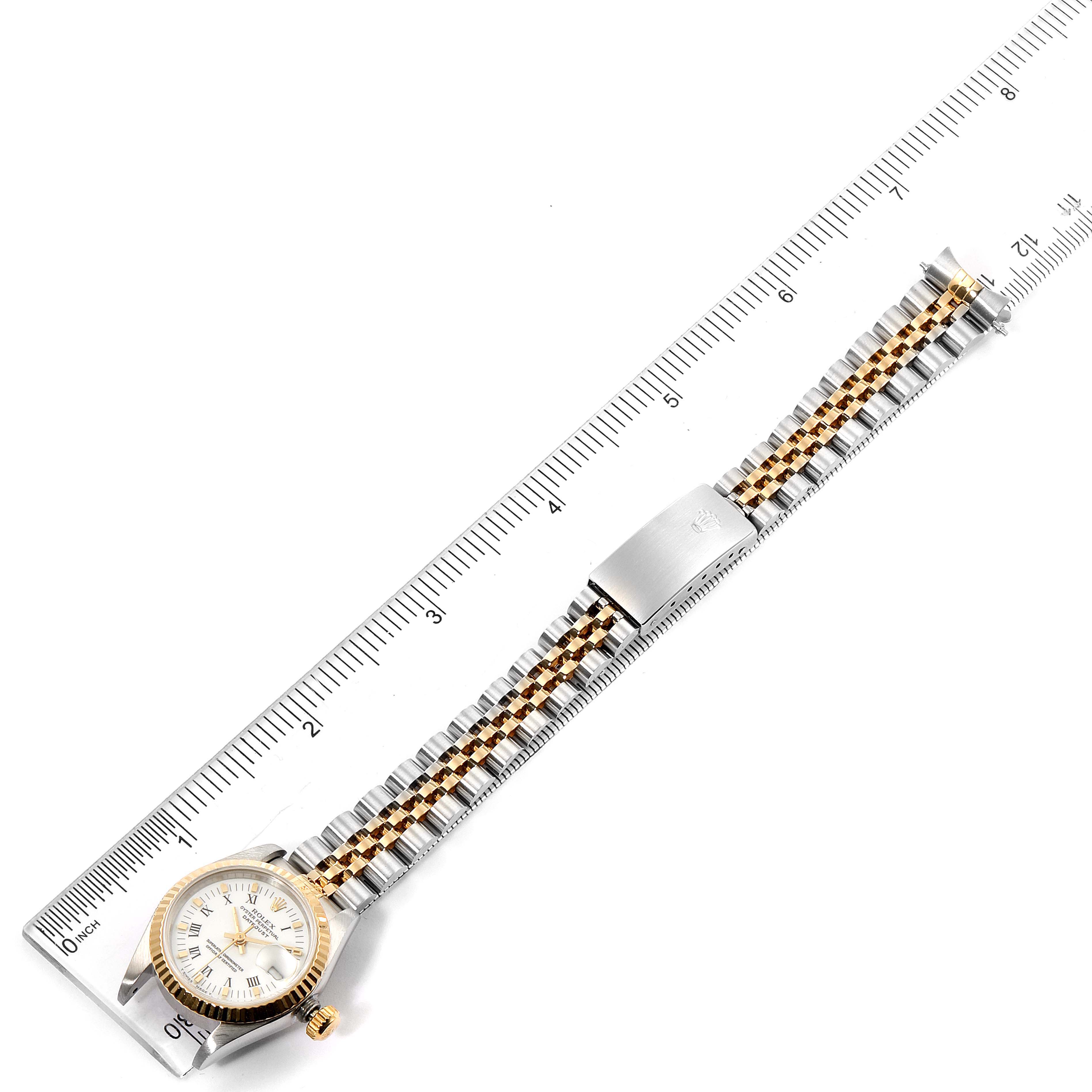 The image shows a Rolex Datejust 69173 Women's Steel and Gold (two tone) White Dial 69173 Women's Steel and Gold (two tone) White Dial watch laid flat beside a ruler, highlighting the case, dial, bracelet, and clasp.