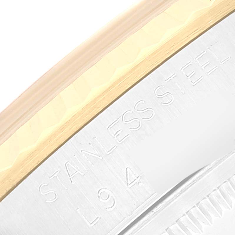 This close-up image shows the "STAINLESS STEEL" engraving and part of the bezel on a Rolex Datejust 16233 Men's Steel and Gold (two tone) White Dial 16233 Men's Steel and Gold (two tone) White Dial watch.