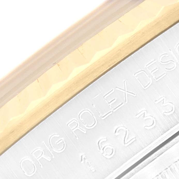 This image shows a close-up of the side of a Rolex Datejust 16233 Men's Steel and Gold (two tone) White Dial 16233 Men's Steel and Gold (two tone) White Dial watch with visible engravings and part of the bezel.