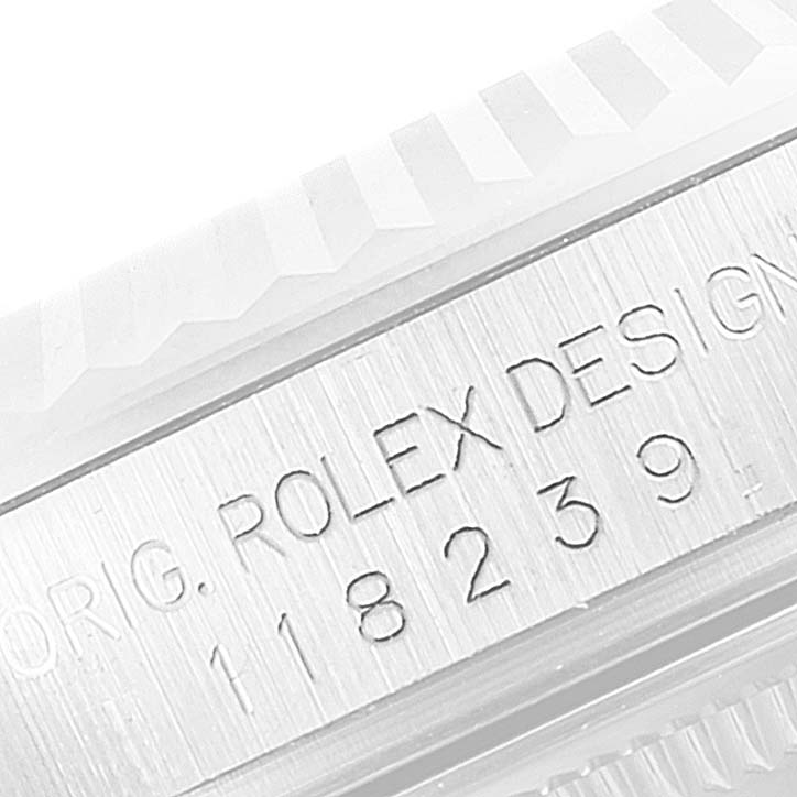 This image shows a close-up of the engraved model number and "ROLEX DESIGN" text on the Rolex President 118239 Men's White Gold Silver Dial 118239 Men's White Gold Silver Dial watch case.