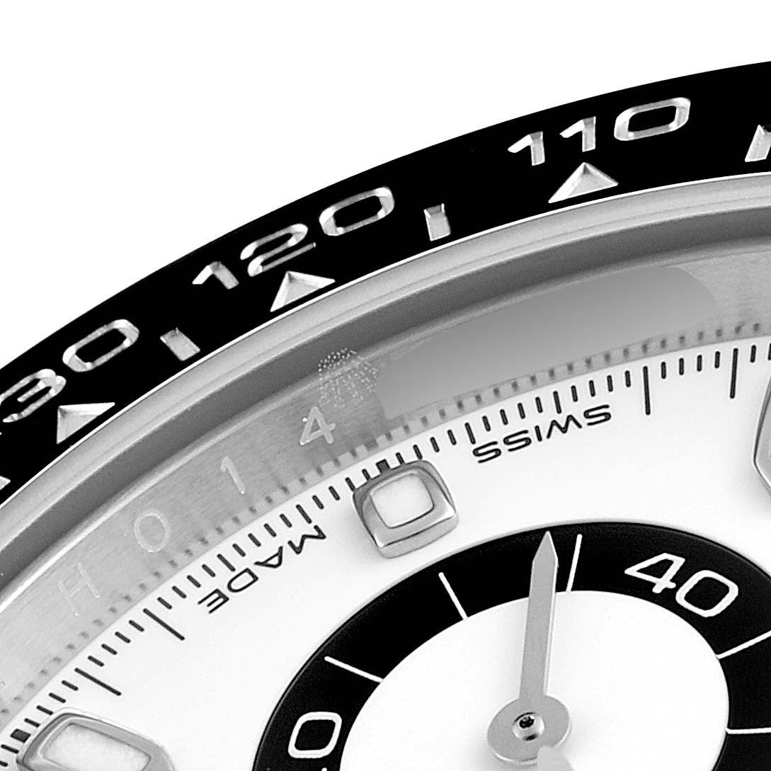 The image shows a close-up of the dial and bezel of a Rolex Daytona 116500 Men's Stainless Steel White Dial 116500 Men's Stainless Steel White Dial watch, focusing on the minute and hour markers.