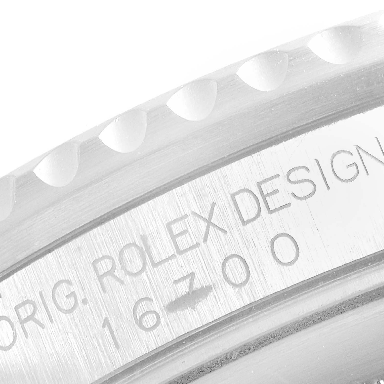 This close-up image shows the bezel and case with engraved text of a Rolex GMT-Master 16700 Men's Stainless Steel Black Dial 16700 Men's Stainless Steel Black Dial watch.