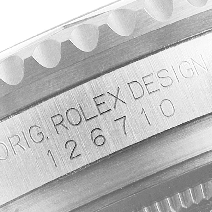This image shows a close-up of the engraved model number "126710" and "ORIG. ROLEX DESIGN" on a Rolex GMT-Master 126710 Men
s Stainless Steel Black Dial 126710 Men
s Stainless Steel Black Dial watch case.