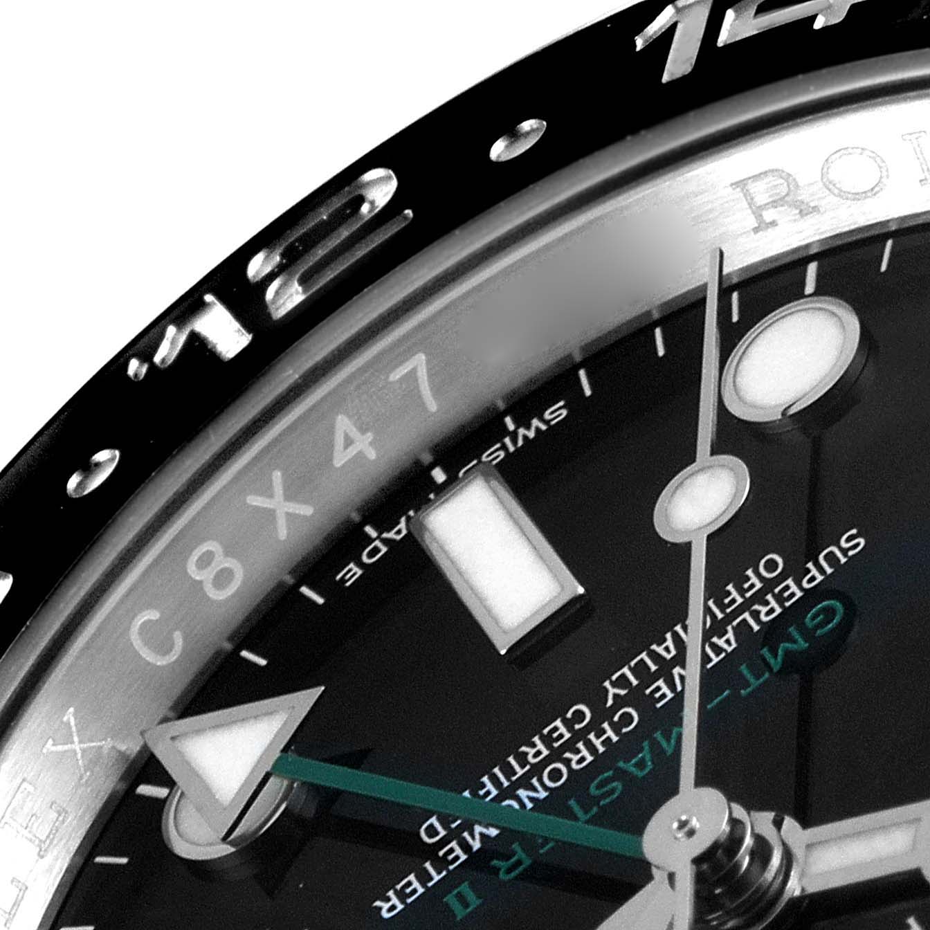 This close-up image of the Rolex GMT-Master 116710 Men's Stainless Steel Black Dial 116710 Men's Stainless Steel Black Dial showcases the bezel, part of the dial, and the hour and minute hands.