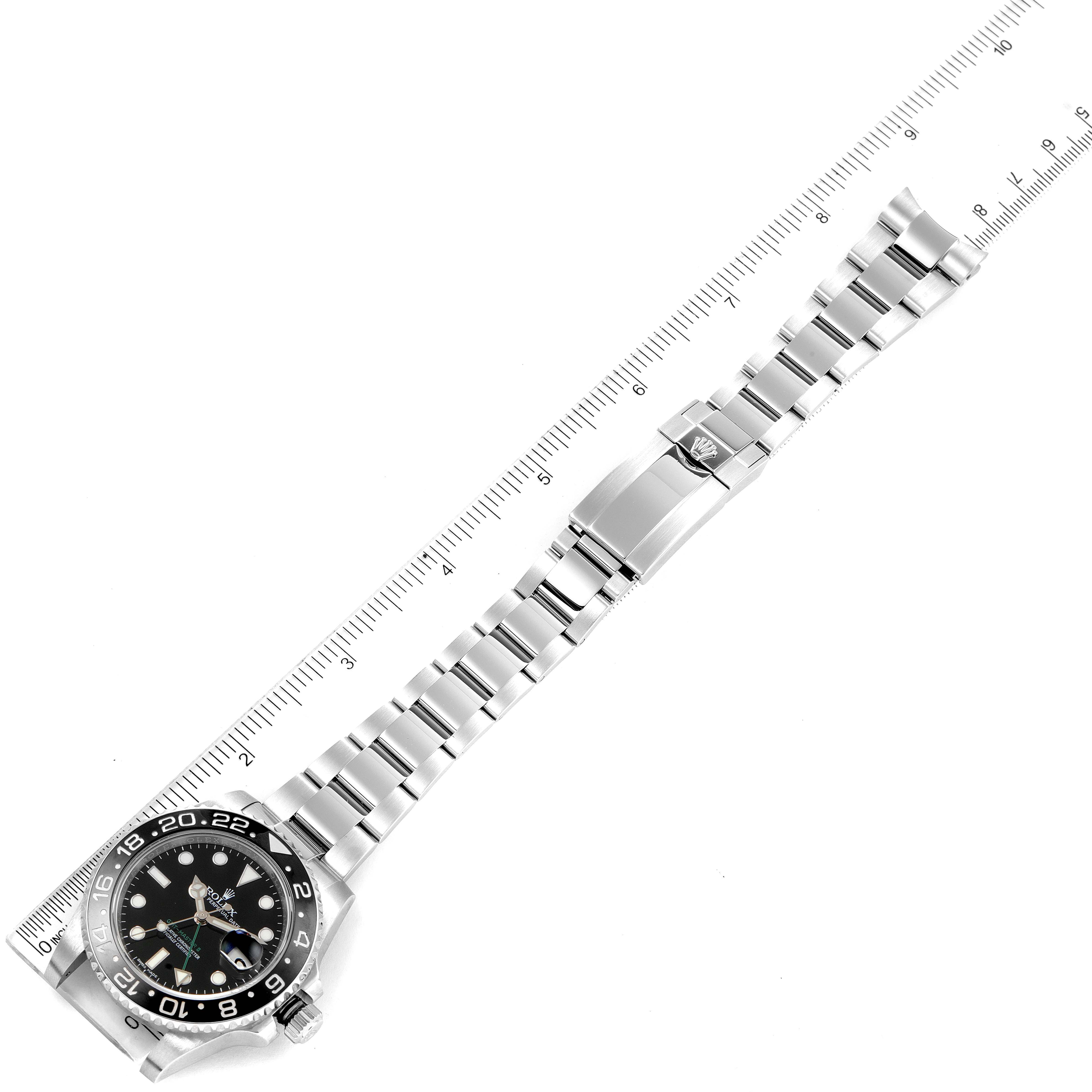 The image shows the Rolex GMT-Master 116710 Men's Stainless Steel Black Dial 116710 Men's Stainless Steel Black Dial watch at an oblique angle, displaying its face, bezel, bracelet, and clasp against a ruler.