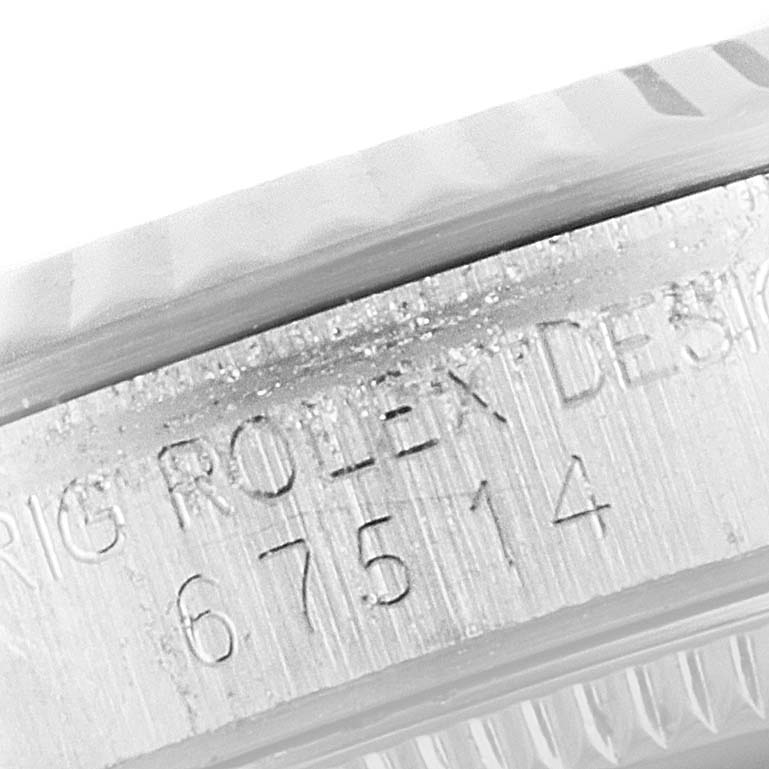 This image shows a close-up of the serial number engraved on the side of the case for a Mid-Size Rolex watch.