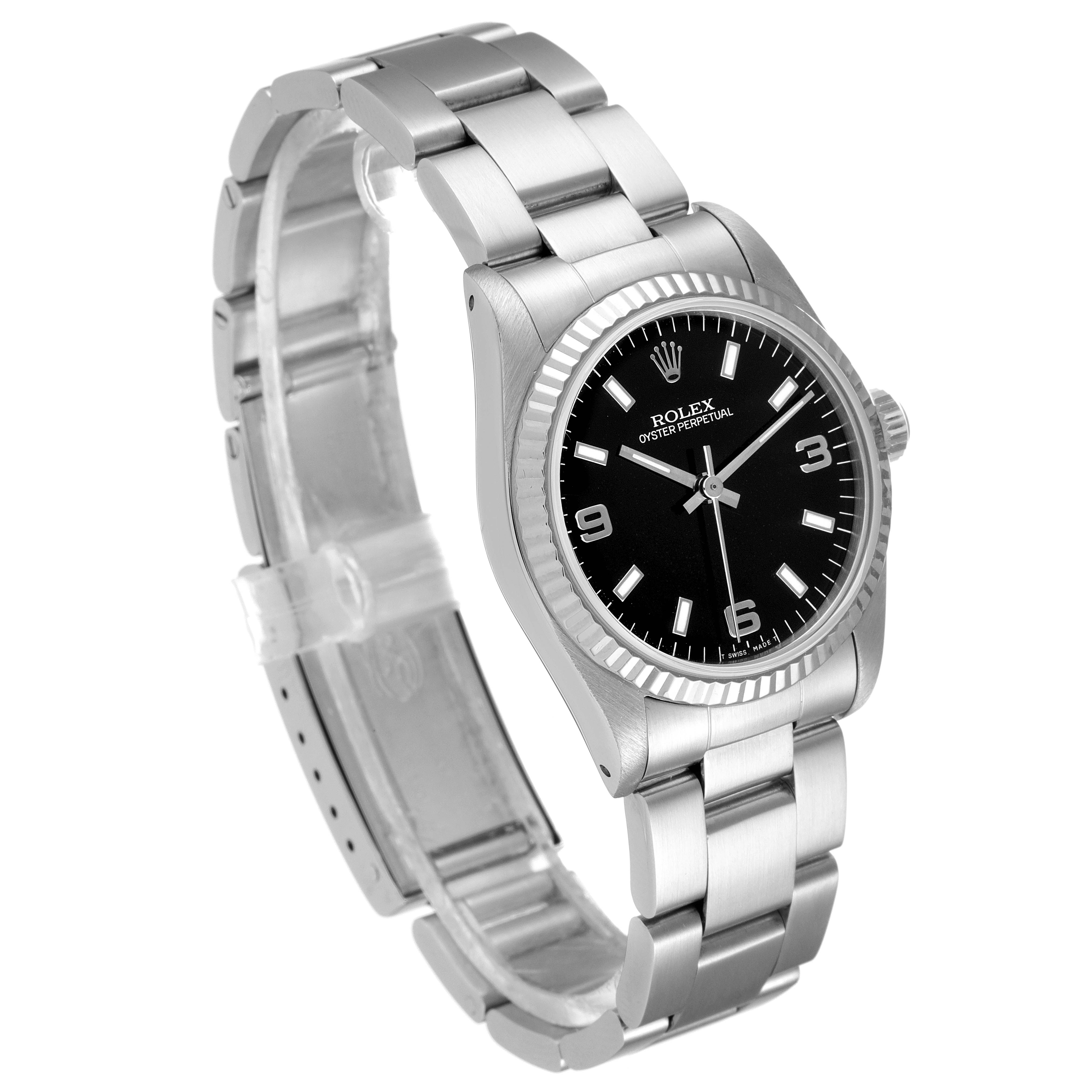 The image shows a Mid-Size Rolex watch angled to display its black dial, fluted bezel, and stainless steel bracelet.