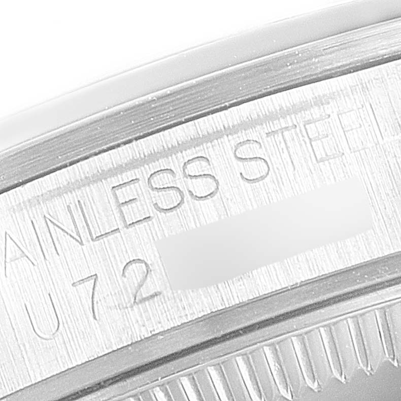 This close-up image shows the engraved text on the stainless steel case back of a mid-size Rolex watch.