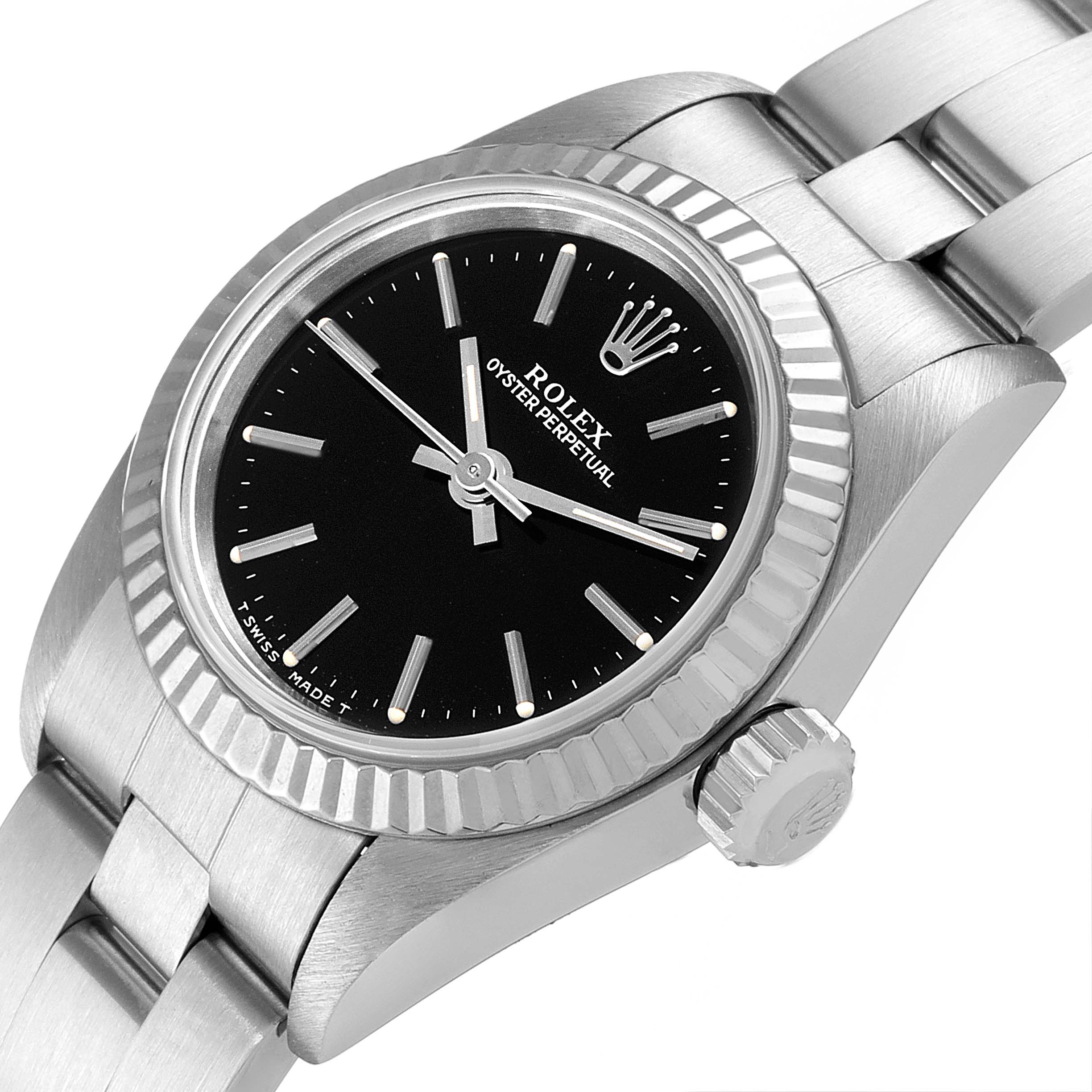 The image shows a Rolex Oyster Perpetual 67194 Women's Stainless Steel Black Dial 67194 Women's Stainless Steel Black Dial watch from an angled top view, highlighting its black dial, stainless steel bezel, and part of the bracelet.