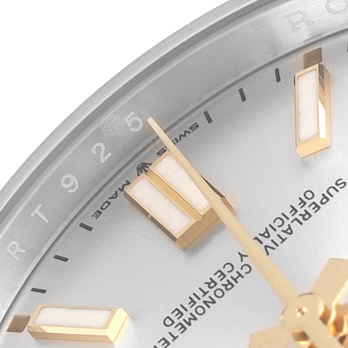 This close-up image shows a portion of the dial of a Rolex Oyster Perpetual 124300 Men's Stainless Steel Silver Dial 124300 Men's Stainless Steel Silver Dial watch, focusing on the hour markers, hands, and bezel.