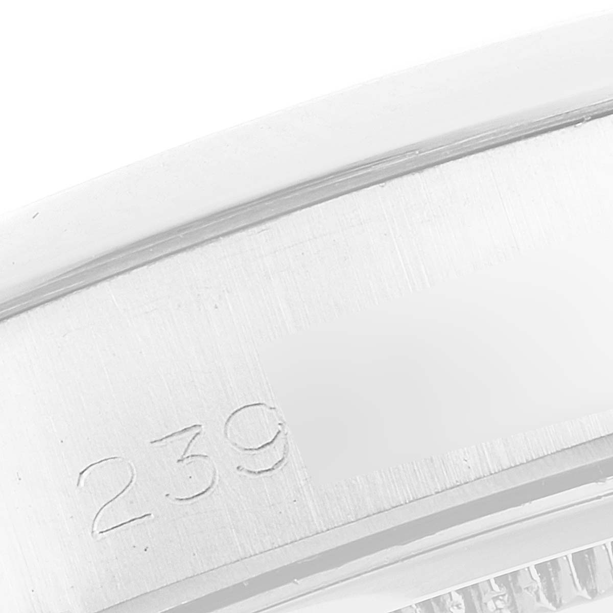 This image shows a close-up of the side of a Rolex Vintage Collection 6694 Men's Stainless Steel Black Dial 6694 Men's Stainless Steel Black Dial watch case, highlighting engraved numbers.