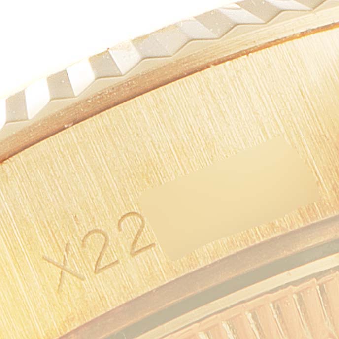 This close-up image shows the edge of the face and a portion of the band of a Rolex President 69178 Women's Yellow Gold Champagne Dial 69178 Women's Yellow Gold Champagne Dial model watch.