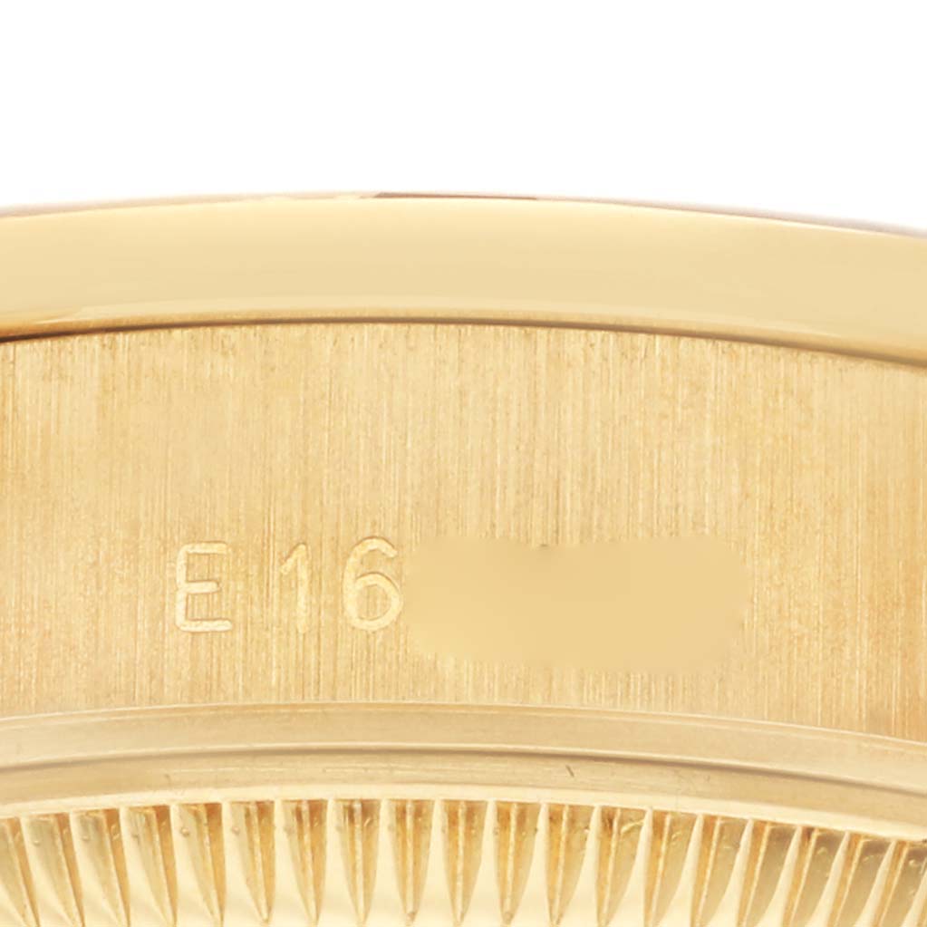 The image shows a close-up of the side bezel and serial number engraving of a Rolex President 69068 Women's Yellow Gold Champagne Dial 69068 Women's Yellow Gold Champagne Dial model watch.