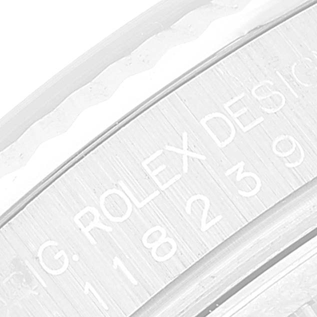 This image shows an angled close-up of the engraving on a Rolex President 118239 Men's White Gold Brown Dial 118239 Men's White Gold Brown Dial model watch.