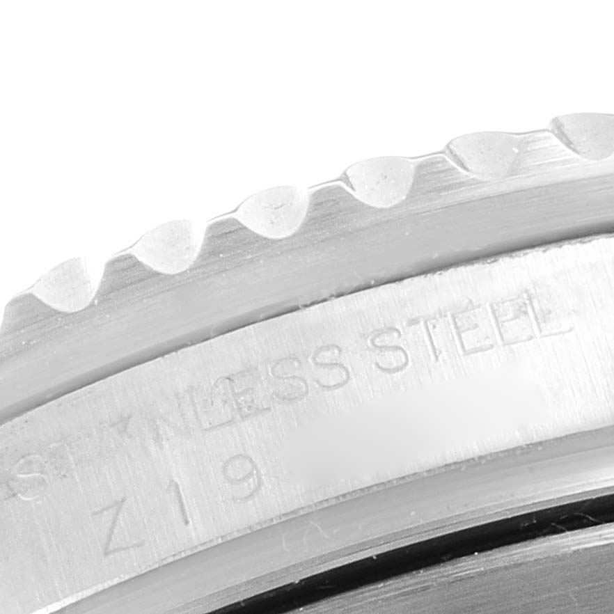 The image shows a close-up of the bezel and case side of a Rolex Submariner 16610 Men's Stainless Steel Black Dial 16610 Men's Stainless Steel Black Dial watch with "STAINLESS STEEL" engraved.