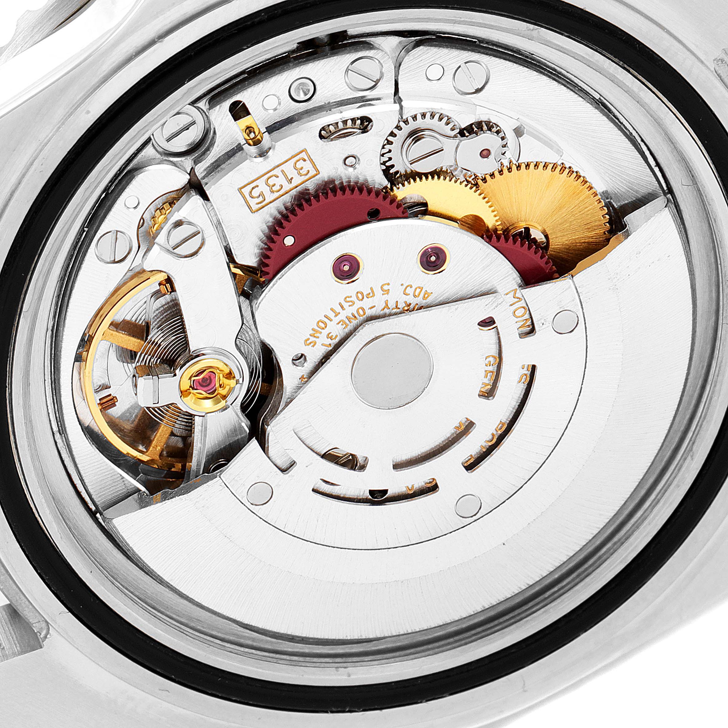 This image shows a close-up view of the movement inside a Rolex Submariner 16610 Men's Stainless Steel Black Dial 16610 Men's Stainless Steel Black Dial watch, displaying intricate gears and mechanical parts.