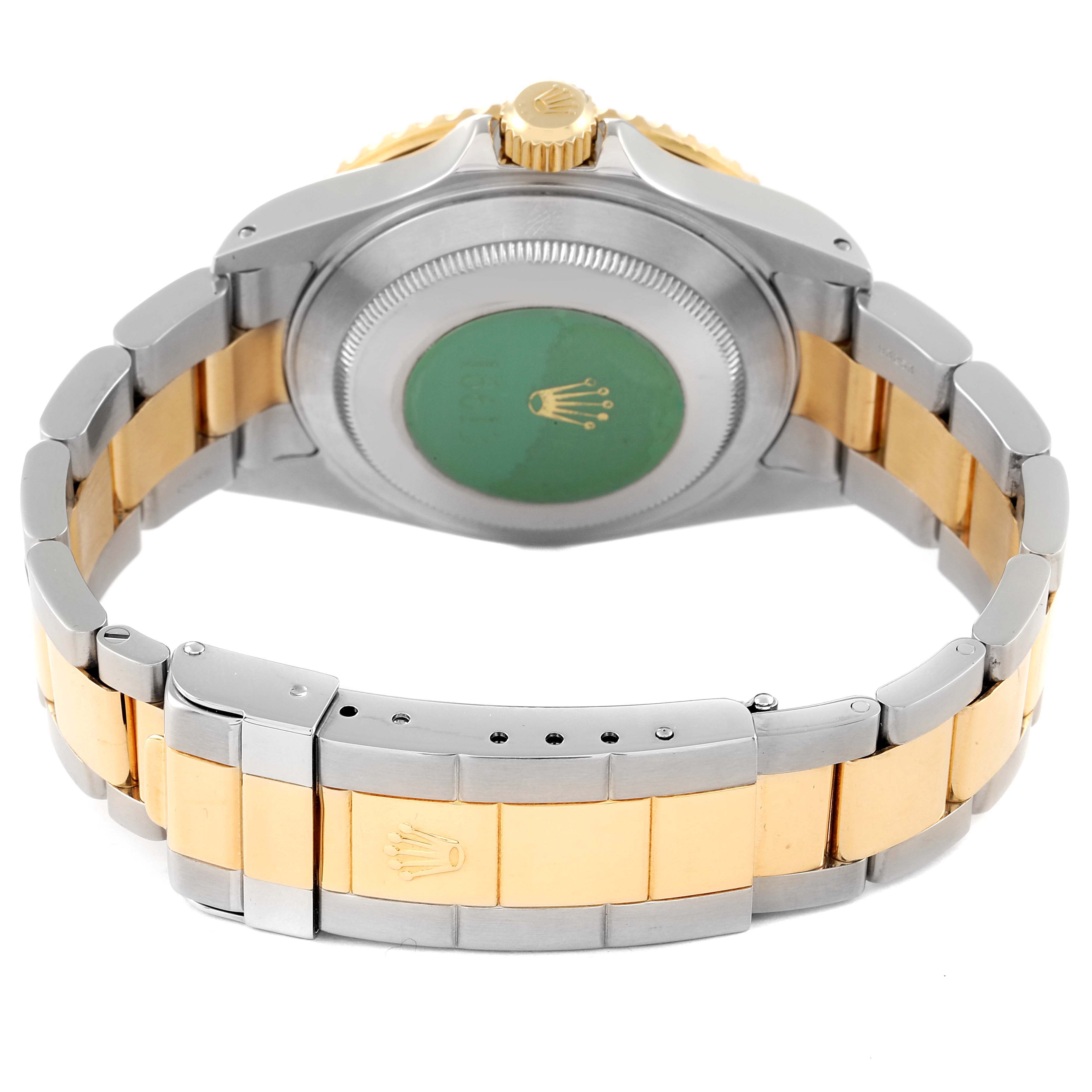 The image shows the back of a Rolex Submariner 16613 Men's Steel and Gold (two tone) Blue Dial 16613 Men's Steel and Gold (two tone) Blue Dial, highlighting the case back and the two-tone bracelet.