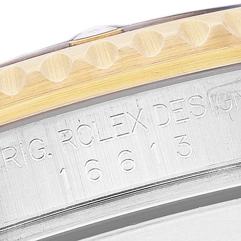 The image shows a close-up of the bezel and engraved case side of a Rolex Submariner 16613 Men's Steel and Gold (two tone) Blue Dial 16613 Men's Steel and Gold (two tone) Blue Dial model.