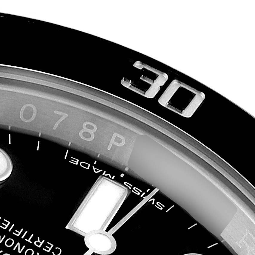 This close-up image of a Rolex Submariner 116610 Men's Stainless Steel Black Dial 116610 Men's Stainless Steel Black Dial watch shows the 30-minute mark on the bezel and parts of the dial, including hour markers.