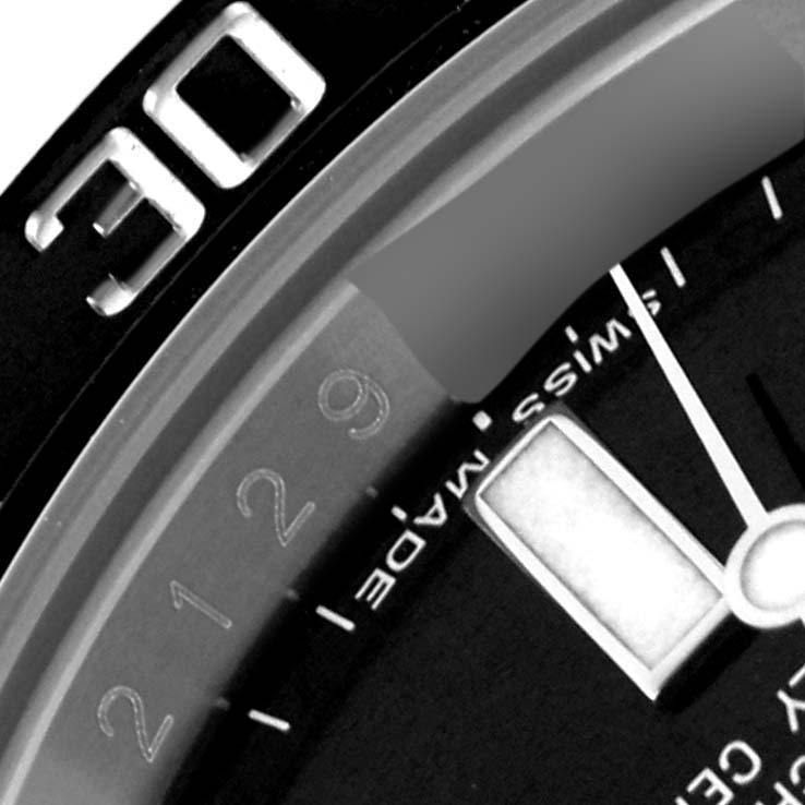 The image shows a close-up of the bezel and dial of a Rolex Submariner 116610 Men
s Stainless Steel Black Dial 116610 Men
s Stainless Steel Black Dial, highlighting the minute markers and part of the hand.