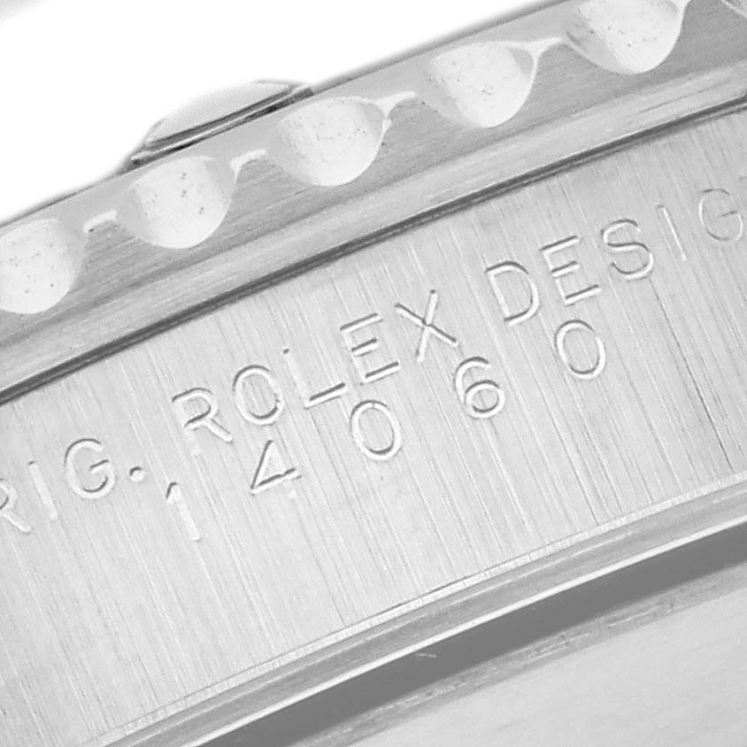 The image shows a close-up of the Rolex Submariner 14060 Men
s Stainless Steel Black Dial 14060 Men
s Stainless Steel Black Dial watch case, highlighting the engraved model number "14060".