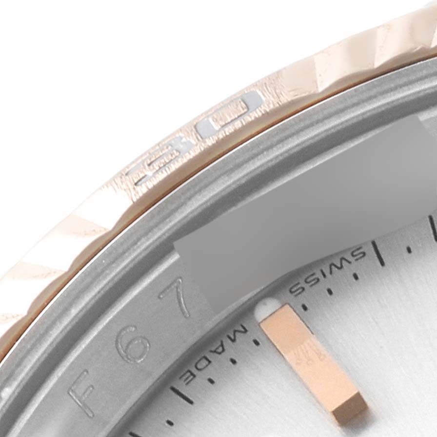 The image shows a close-up of the bezel and partial dial of the Rolex Turn-o-Graph 116261 Men's Steel and Gold (two tone) Silver Dial 116261 Men's Steel and Gold (two tone) Silver Dial watch.