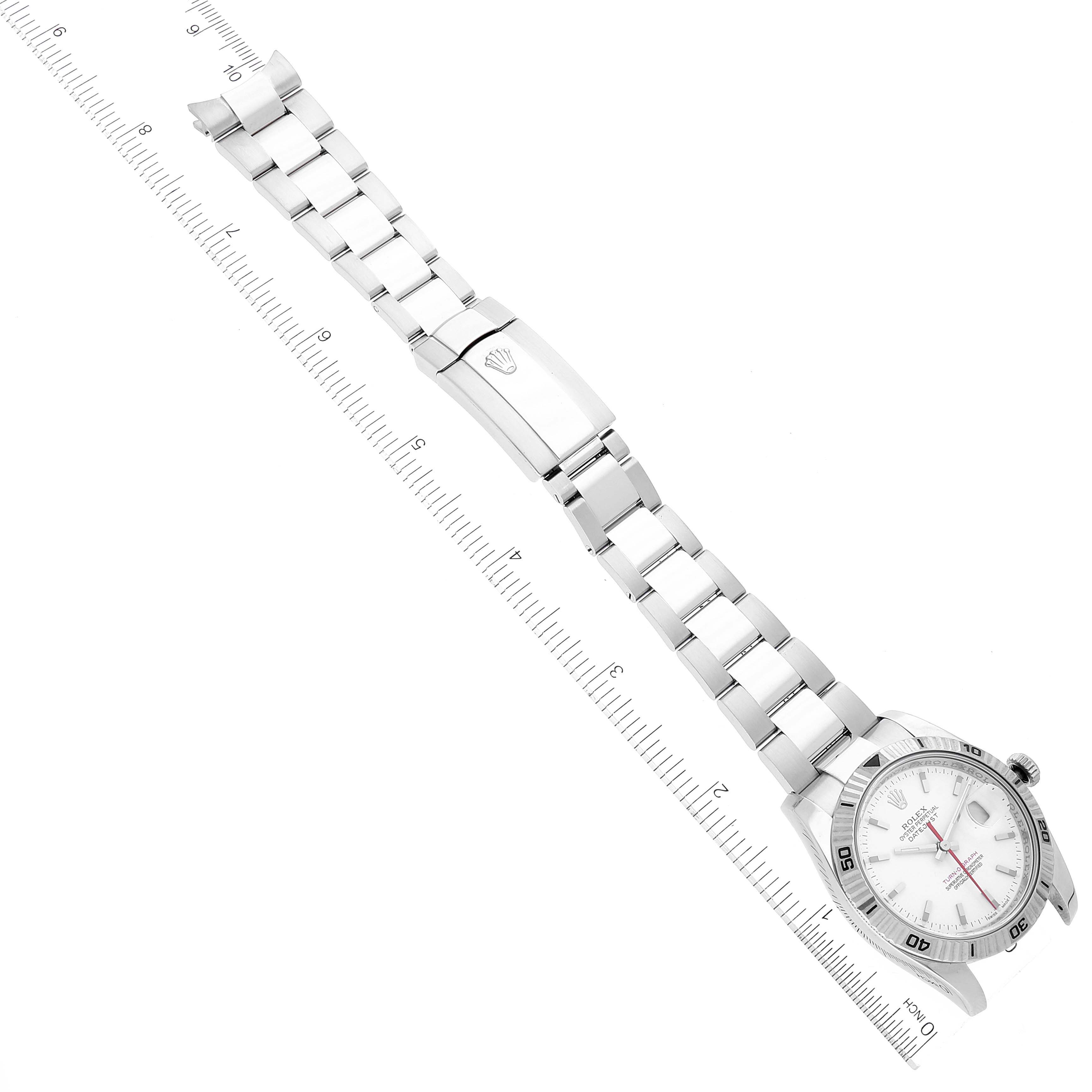 The image shows a Rolex Turn-o-Graph 116264 Men's Stainless Steel White Dial 116264 Men's Stainless Steel White Dial watch laid flat with its band fully extended alongside a measuring ruler.