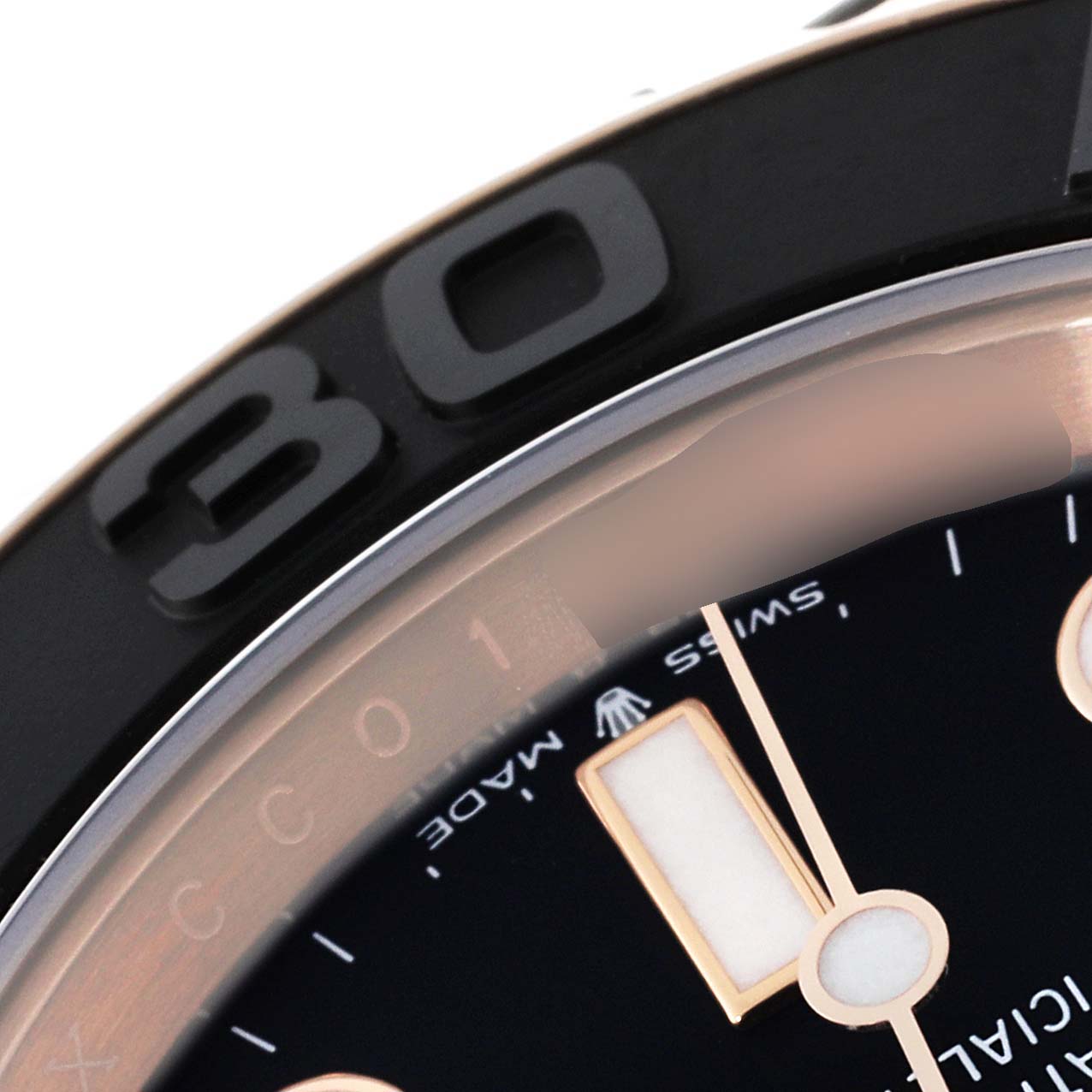 This close-up image of a Rolex Yacht-Master 126655 Men's Rose Gold Black Dial 126655 Men's Rose Gold Black Dial watch shows part of the bezel, dial, and the "Swiss Made" text.