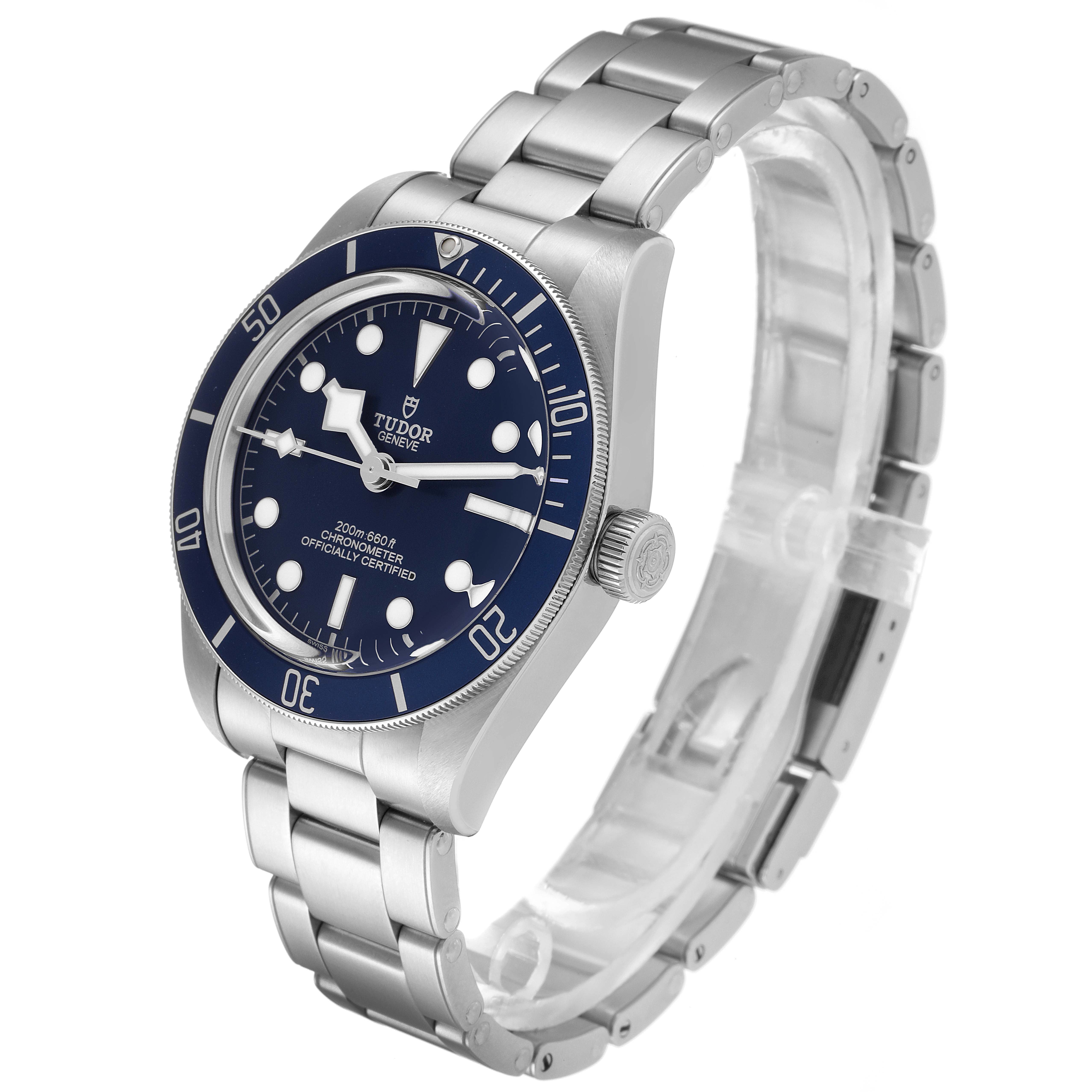 The Tudor Heritage Black Bay 79030B Men's Stainless Steel Blue Dial 79030B Men's Stainless Steel Blue Dial watch is shown from an oblique angle, displaying the face, bezel, crown, and metal bracelet band.