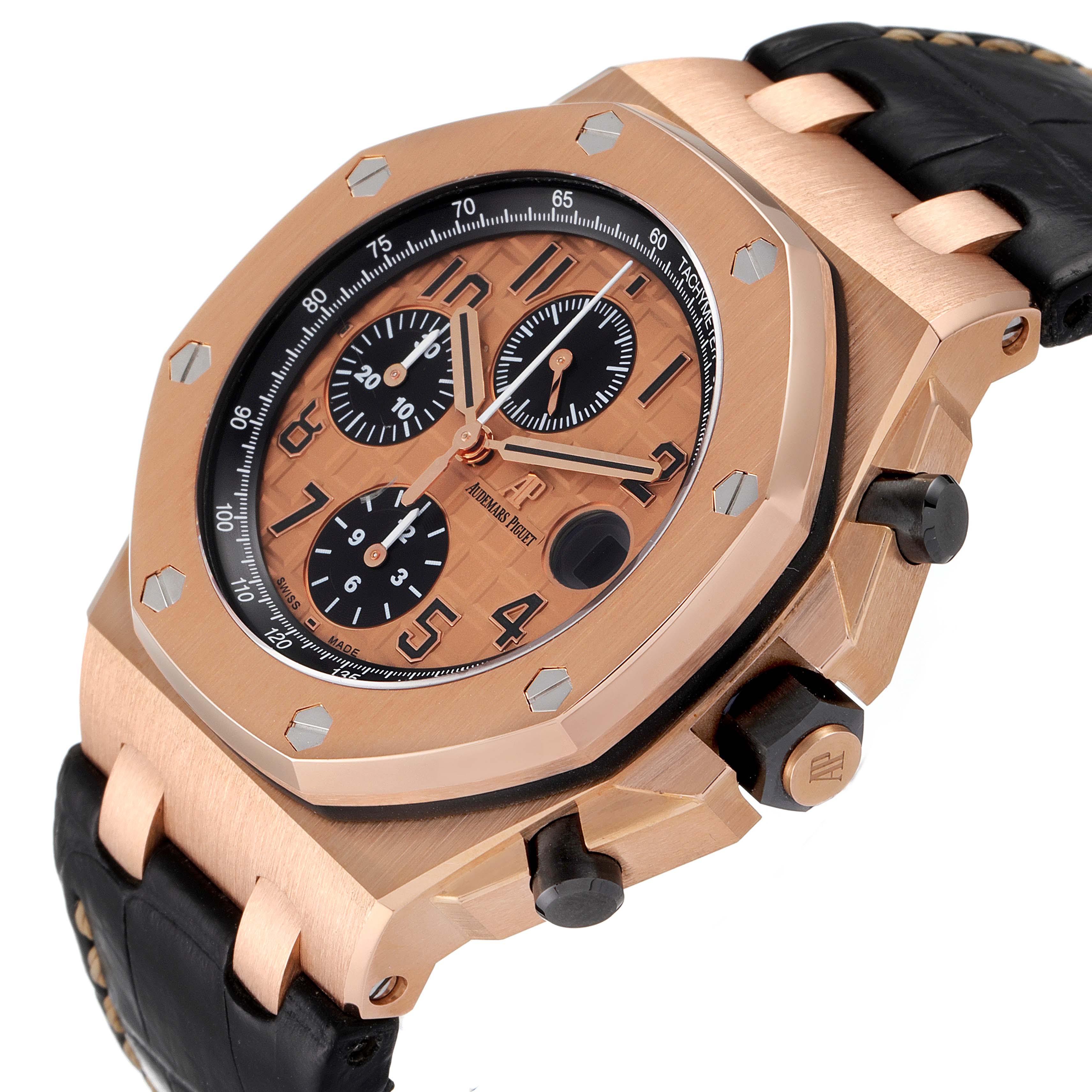 The image shows an angled view of the Audemars Piguet Royal Oak Offshore 26470OR.OO.A002CR.01 Men's Rose Gold Pink Dial 26470OR.OO.A002CR.01 Men's Rose Gold Pink Dial watch, highlighting the face, bezel, and part of the strap.