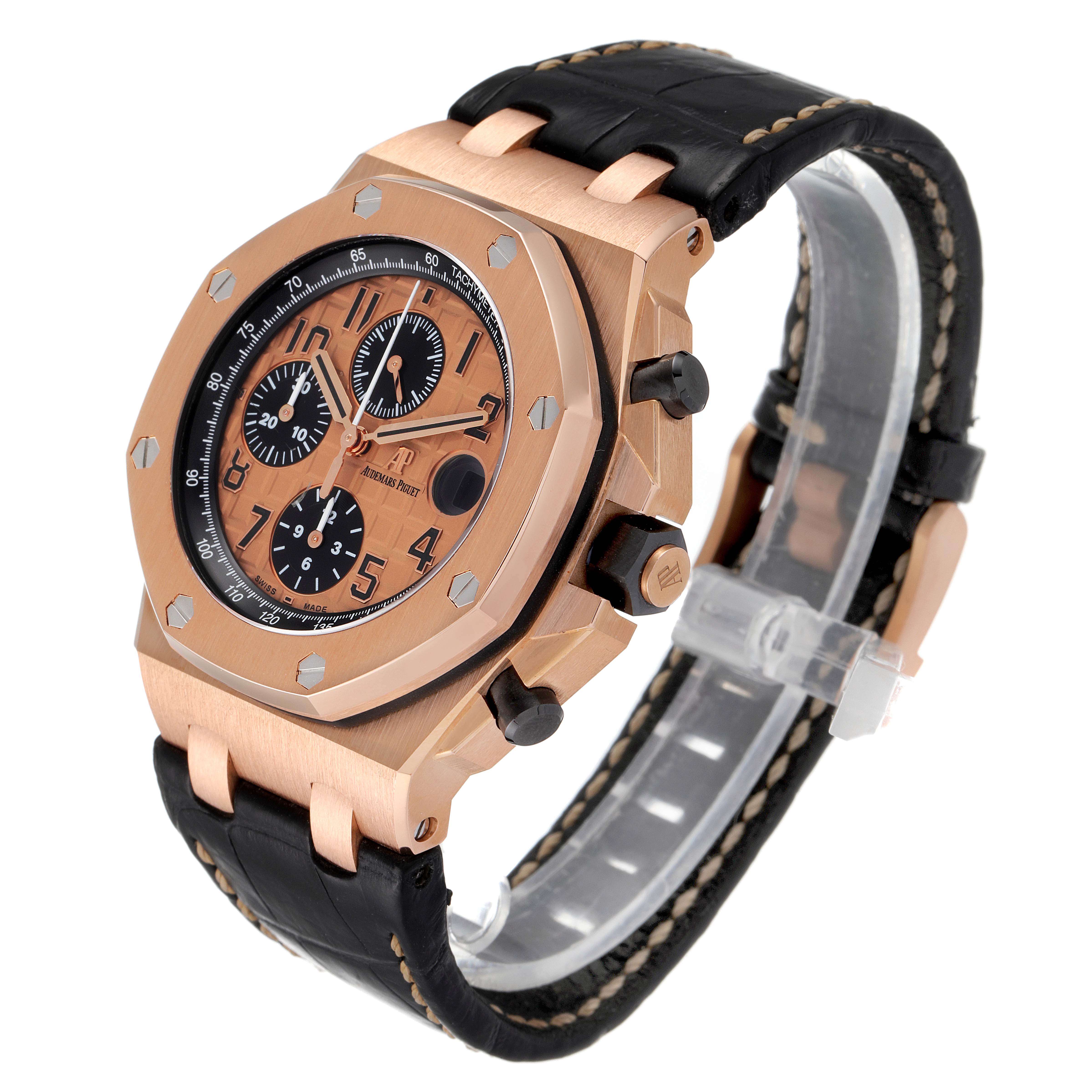This image shows an angled side view of the Audemars Piguet Royal Oak Offshore 26470OR.OO.A002CR.01 Men's Rose Gold Pink Dial 26470OR.OO.A002CR.01 Men's Rose Gold Pink Dial watch, highlighting the dial, bezel, and strap.