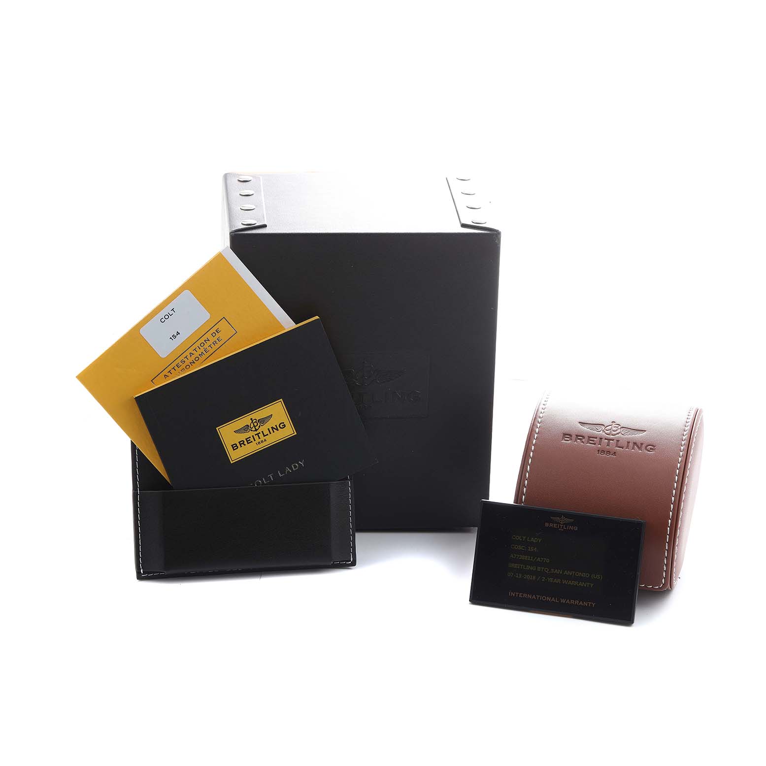 The image shows the Breitling A77388 Women's Stainless Steel Mother of Pearl Dial Colt Lady Steel accessories including the box, warranty cards, and a travel case at a three-quarter angle.