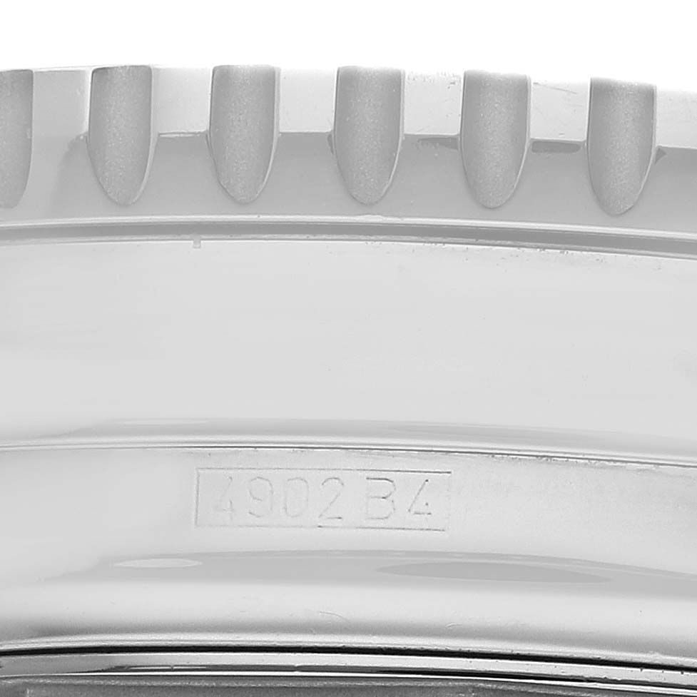 The image shows a close-up of the textured edge and serial number of a Breitling Navitimer A22322 Men
s Stainless Steel White Dial A22322 Men
s Stainless Steel White Dial watch.
