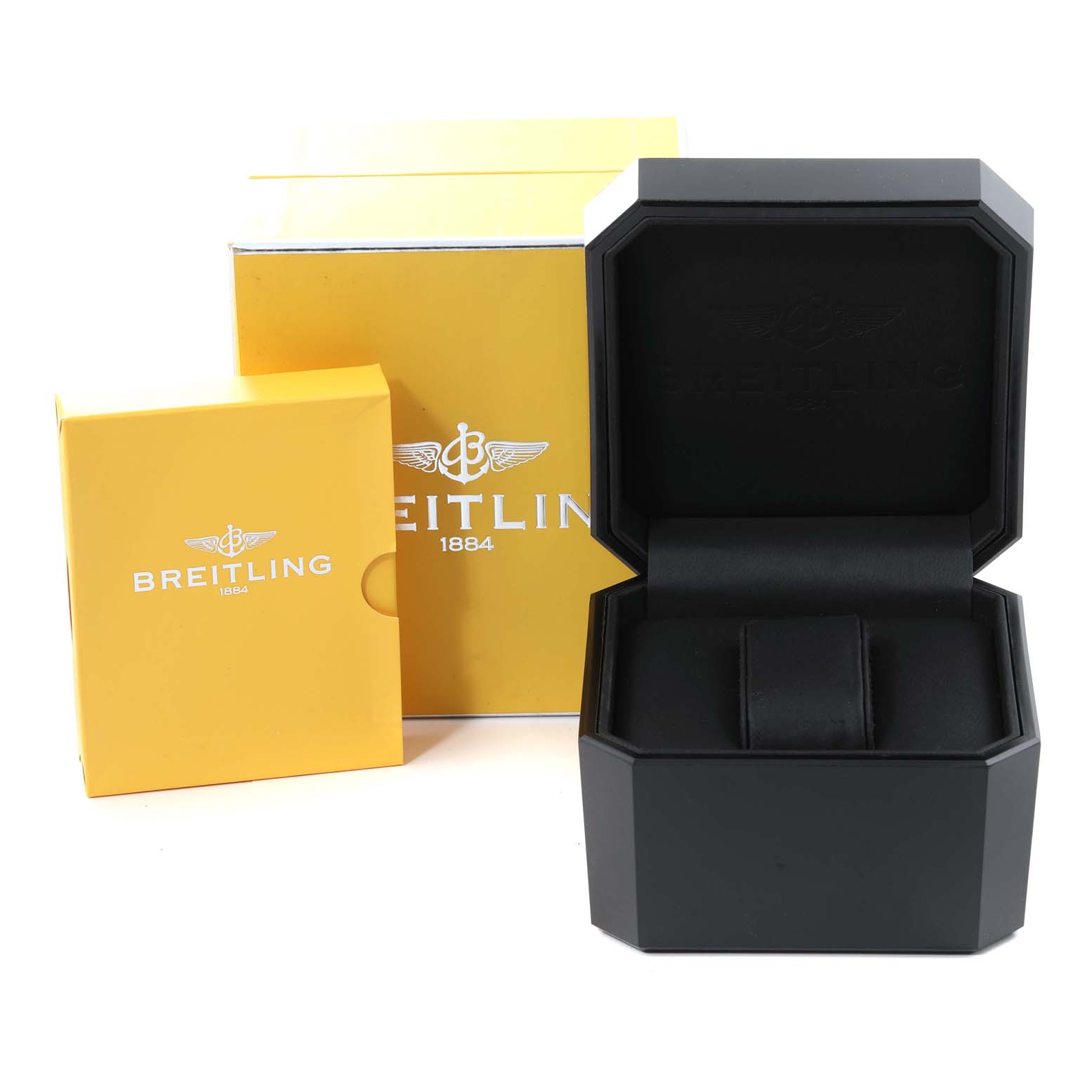 This image shows the packaging of a Breitling Navitimer A22322 Men
s Stainless Steel White Dial A22322 Men
s Stainless Steel White Dial, including an open black watch box and yellow branded outer boxes.