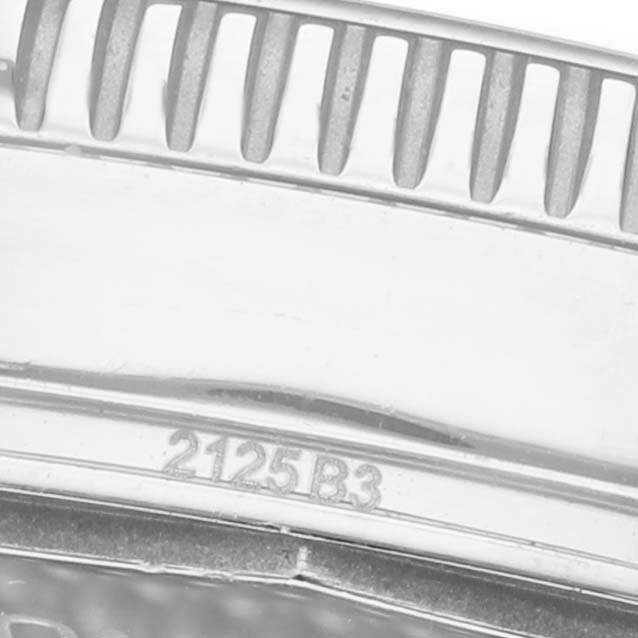 The image shows a close-up of the bezel edge and case side of a Breitling Superocean AB3111 Men's Stainless Steel Green Dial watch, highlighting the ridges and engraving.