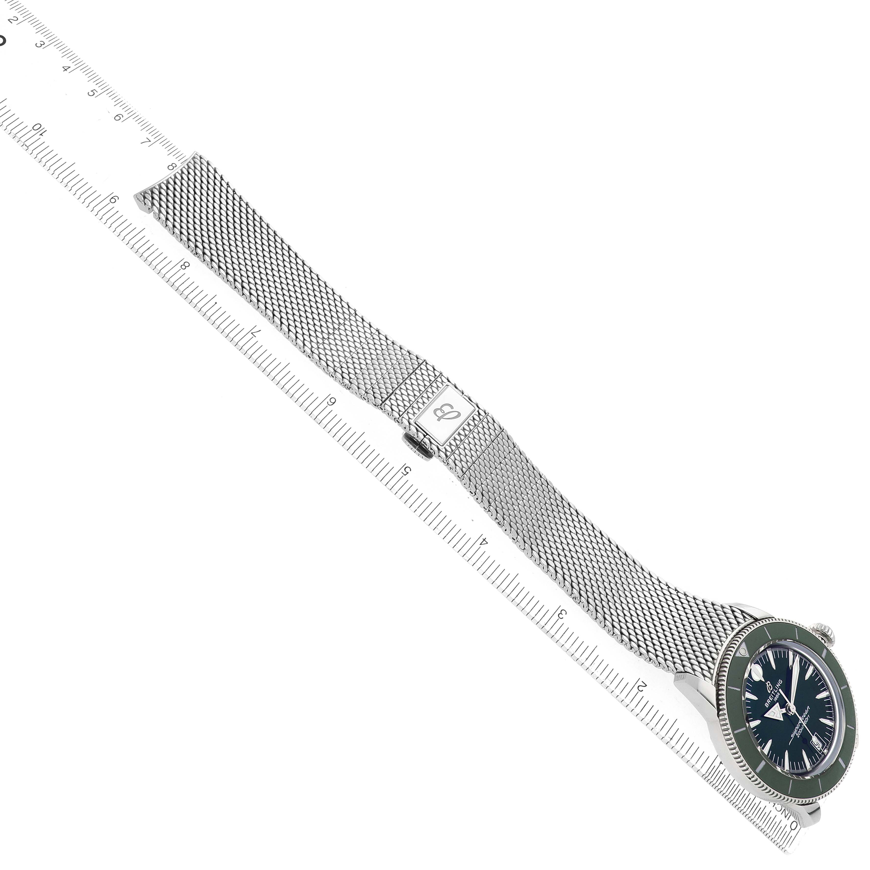 The Breitling Superocean AB3111 Men's Stainless Steel Green Dial watch is shown at a diagonal angle, displaying the face, mesh bracelet, and clasp.