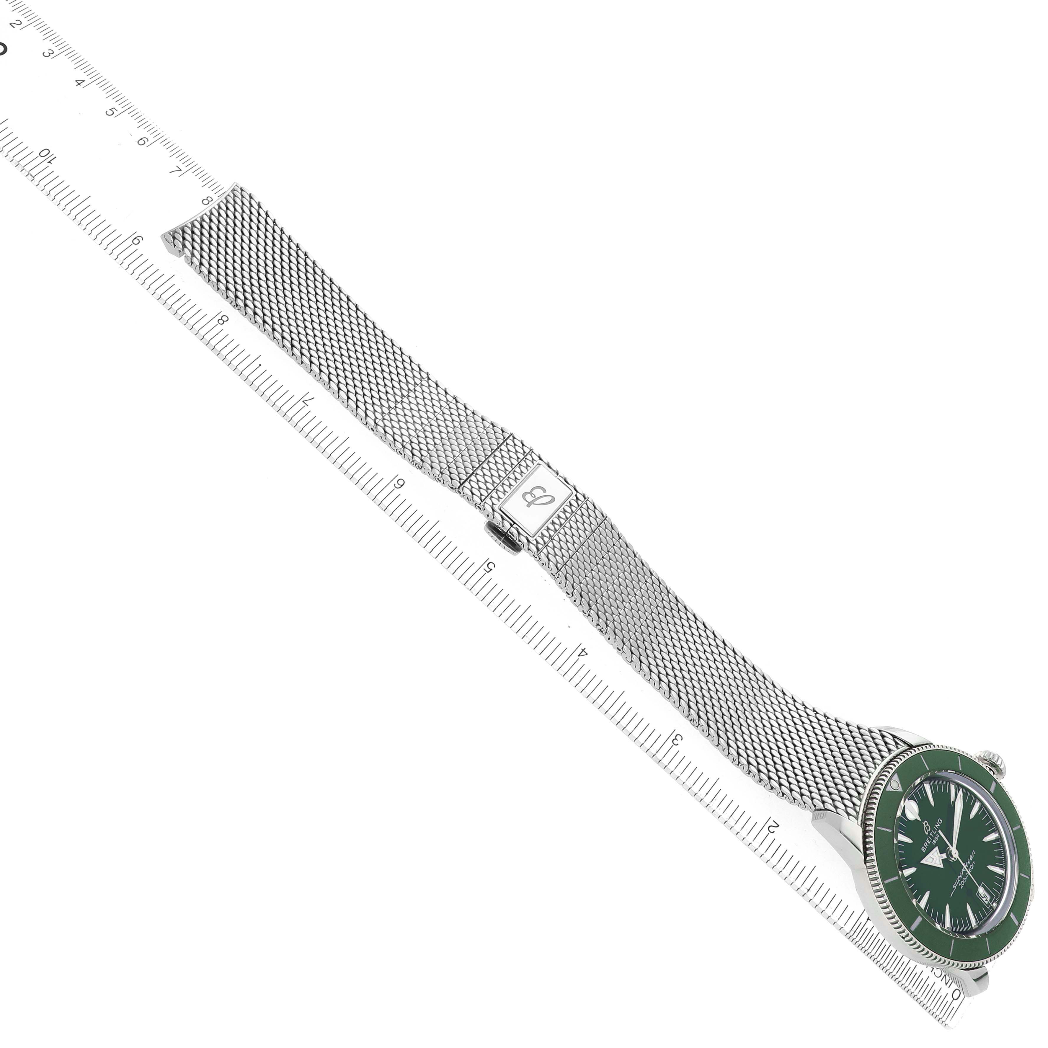 The image shows a side angle of the Superocean by Breitling, highlighting the mesh bracelet and face aligned with a ruler.