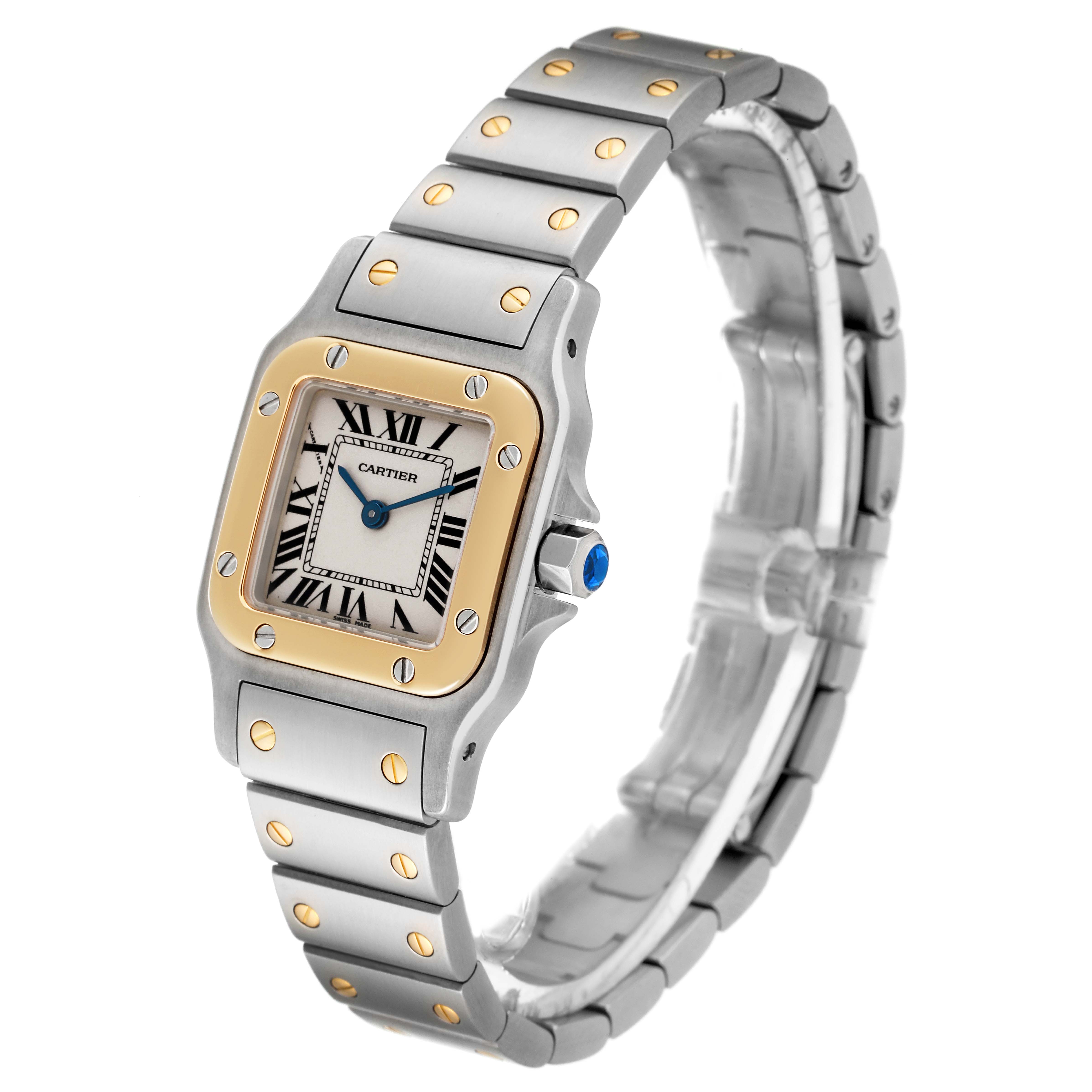 The image shows the Cartier Santos W20012C4 Women's Steel and Gold (two tone) Silver Dial W20012C4 Women's Steel and Gold (two tone) Silver Dial watch at a three-quarter angle, displaying the watch face, band, and crown with a blue gem.