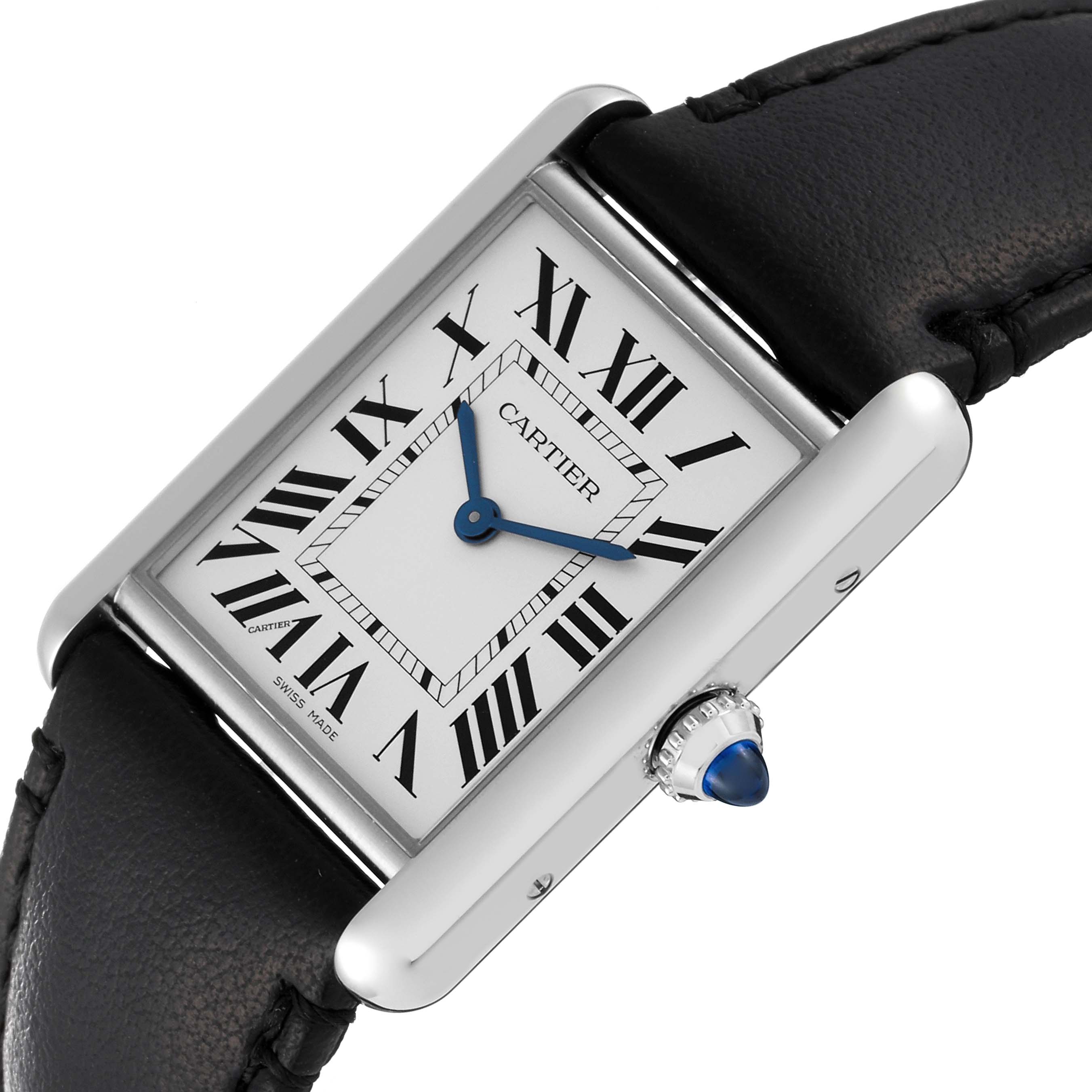 The image shows a Cartier Tank Must WSTA0059 Women's Stainless Steel Silver Dial WSTA0059 Women's Stainless Steel Silver Dial watch at an angled view highlighting its face, Roman numerals, blue hands, and leather strap.
