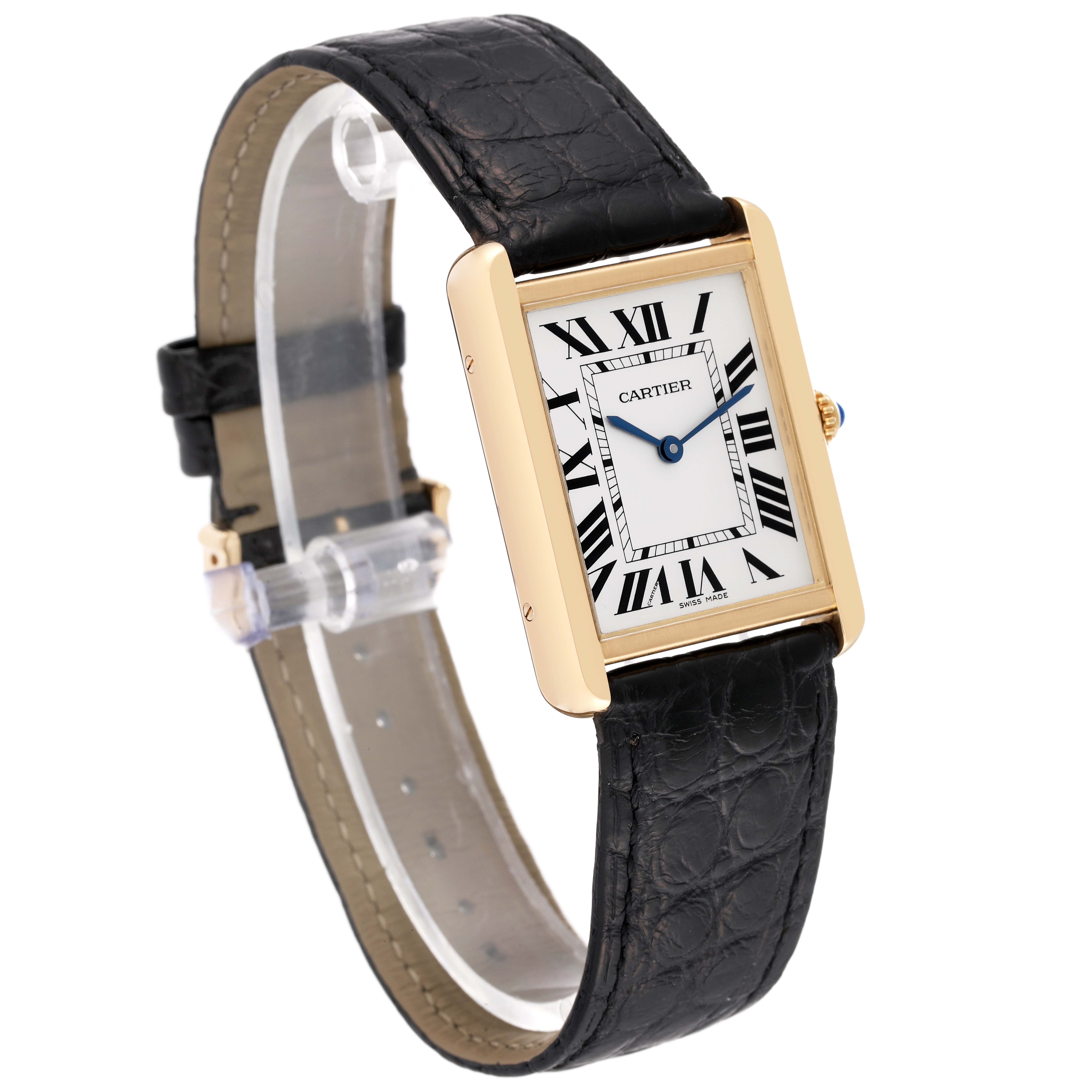 The Tank Solo by Cartier is shown at an oblique angle, highlighting its rectangular face, gold casing, and black leather strap.
