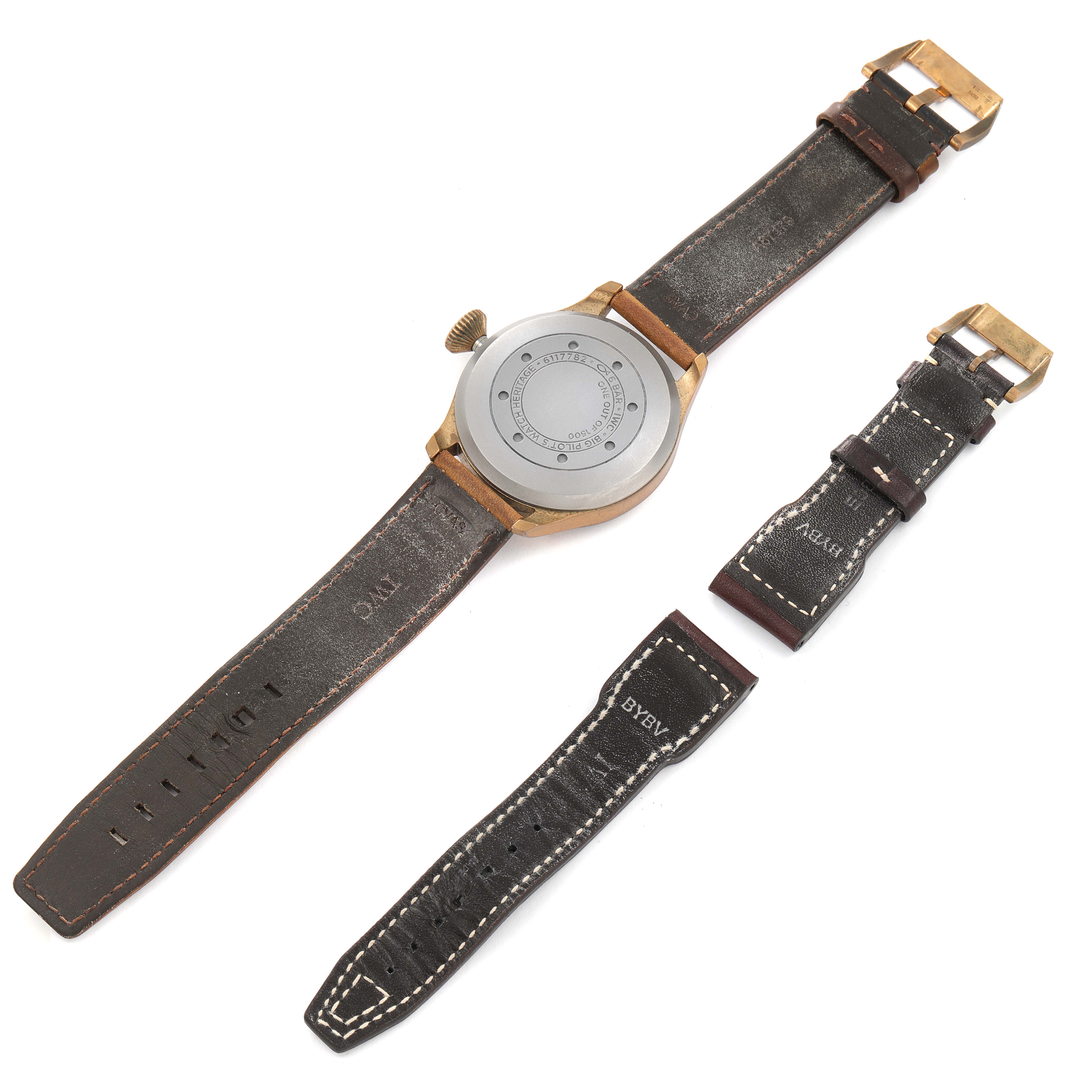 The image shows the back of an IWC Pilot IW501005 Men
s Bronze Black Dial IW501005 Men
s Bronze Black Dial model watch, along with two separate leather watch straps with buckles.