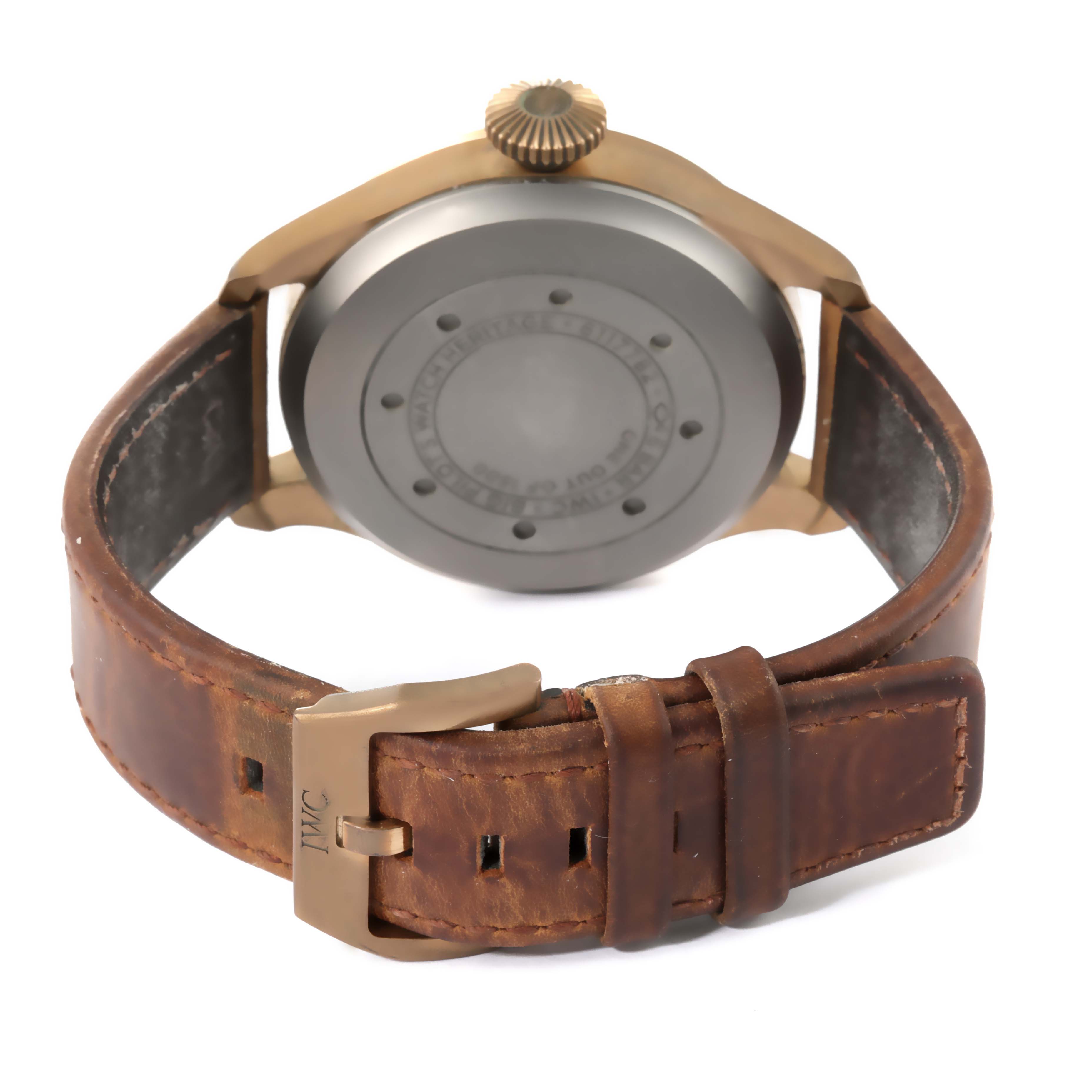 The image shows the back view of an IWC Pilot IW501005 Men
s Bronze Black Dial IW501005 Men
s Bronze Black Dial model watch, highlighting the case, crown, and brown leather strap with the IWC buckle.