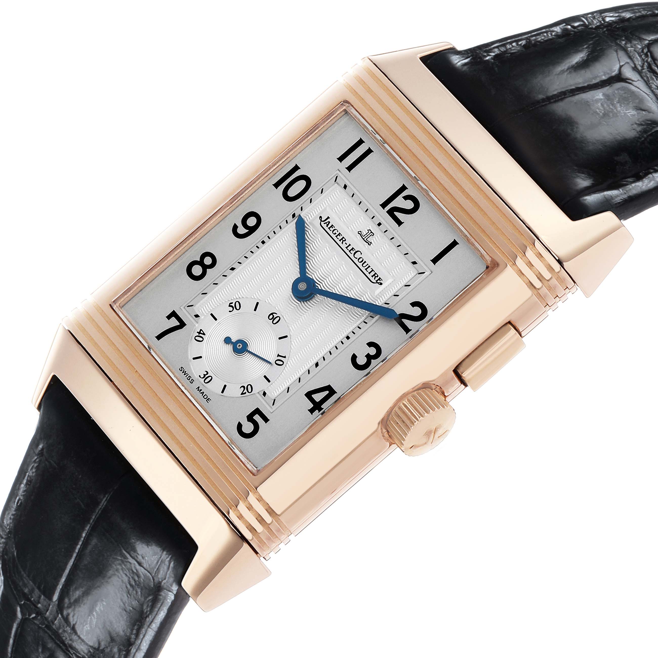 The Jaeger-LeCoultre Reverso watch is shown at an angled side view, highlighting its rectangular face, crown, and part of the leather strap.